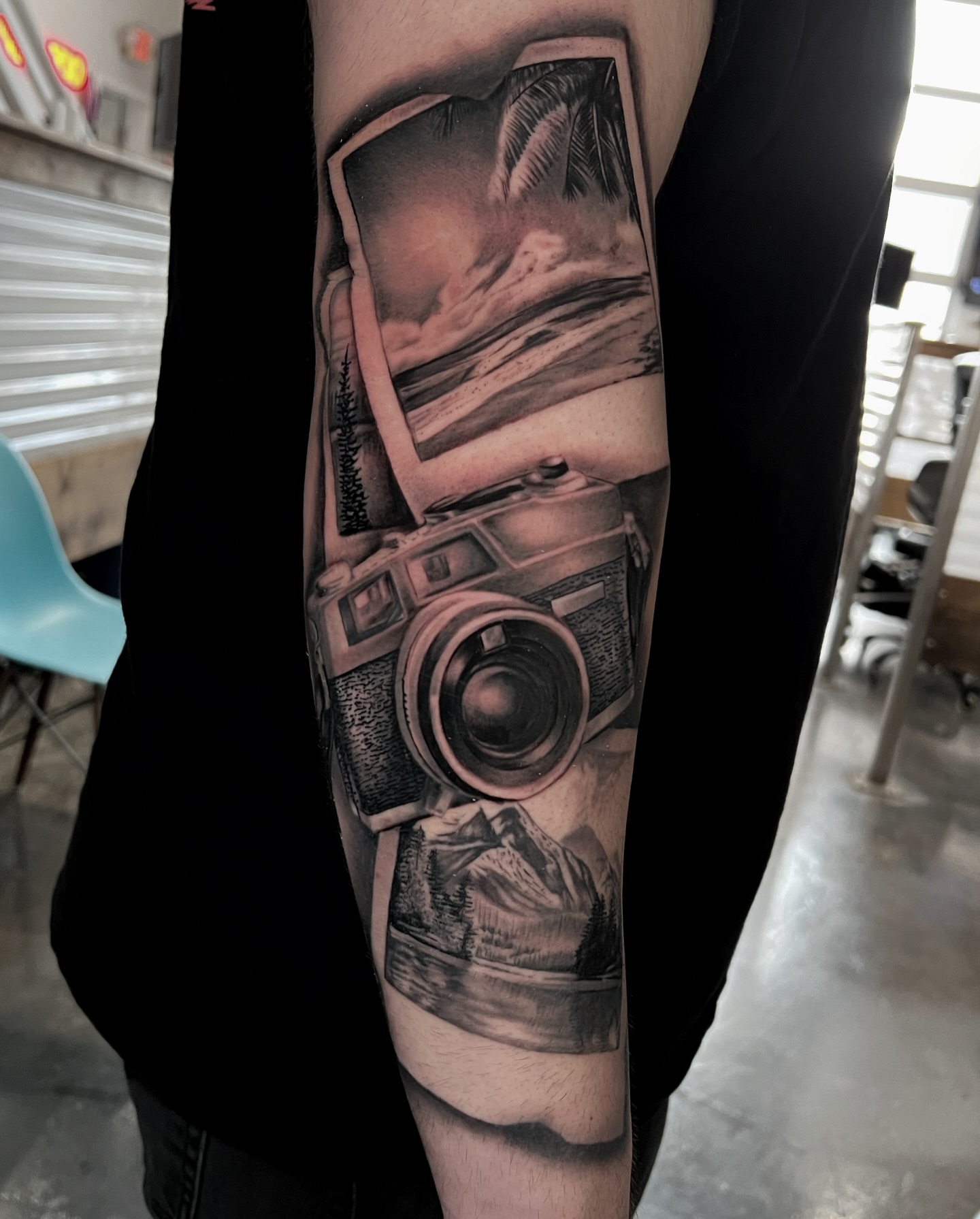 Camera landscape realism tattoo on the forearm by Matt Misiak