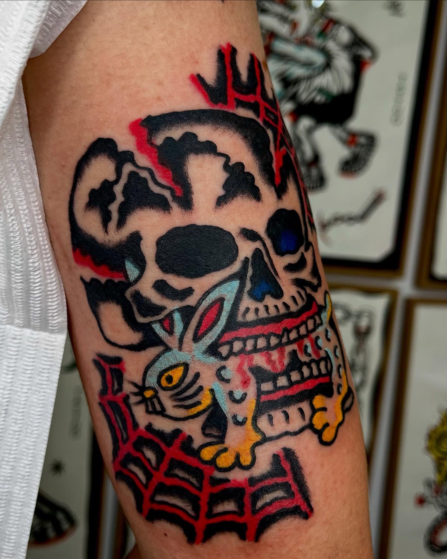 Skull and rabbit American traditional tattoo on the forearm by Jimmy Ho