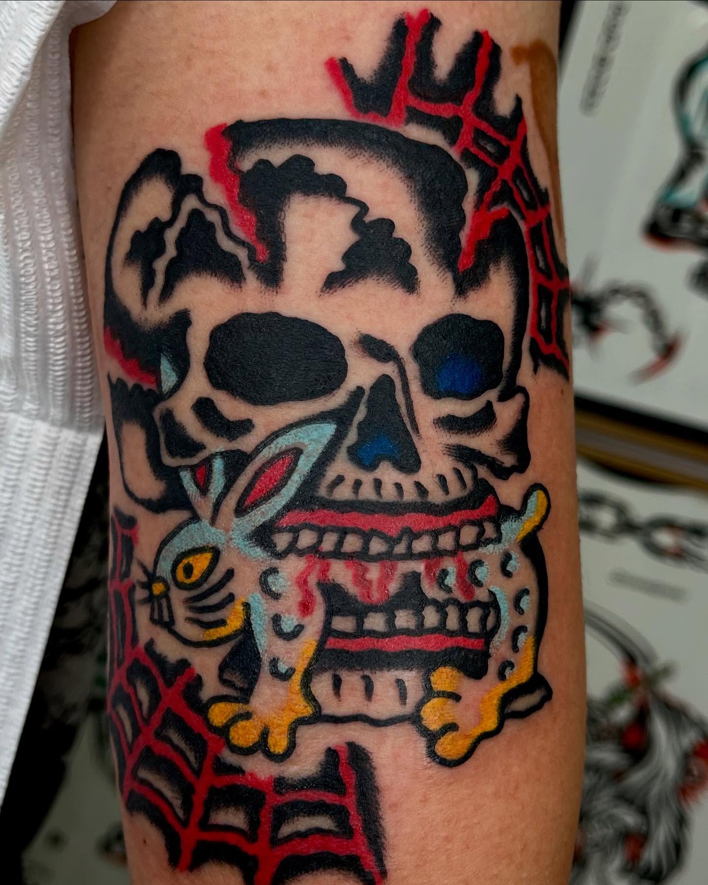 Skull with rabbit American traditional tattoo on the forearm by Jimmy Ho
