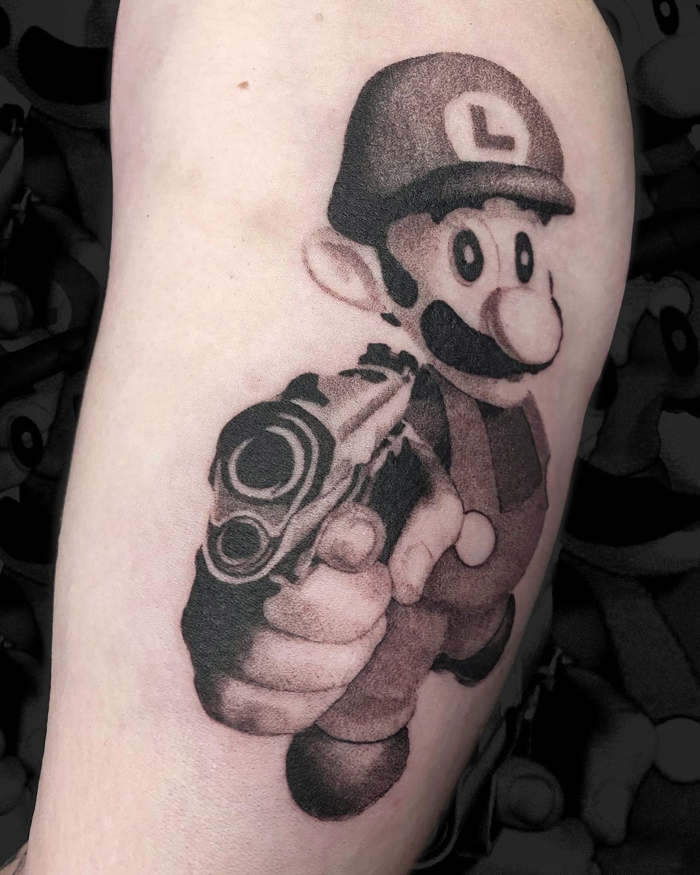 Luigi black and grey tattoo on the forearm by Sarah