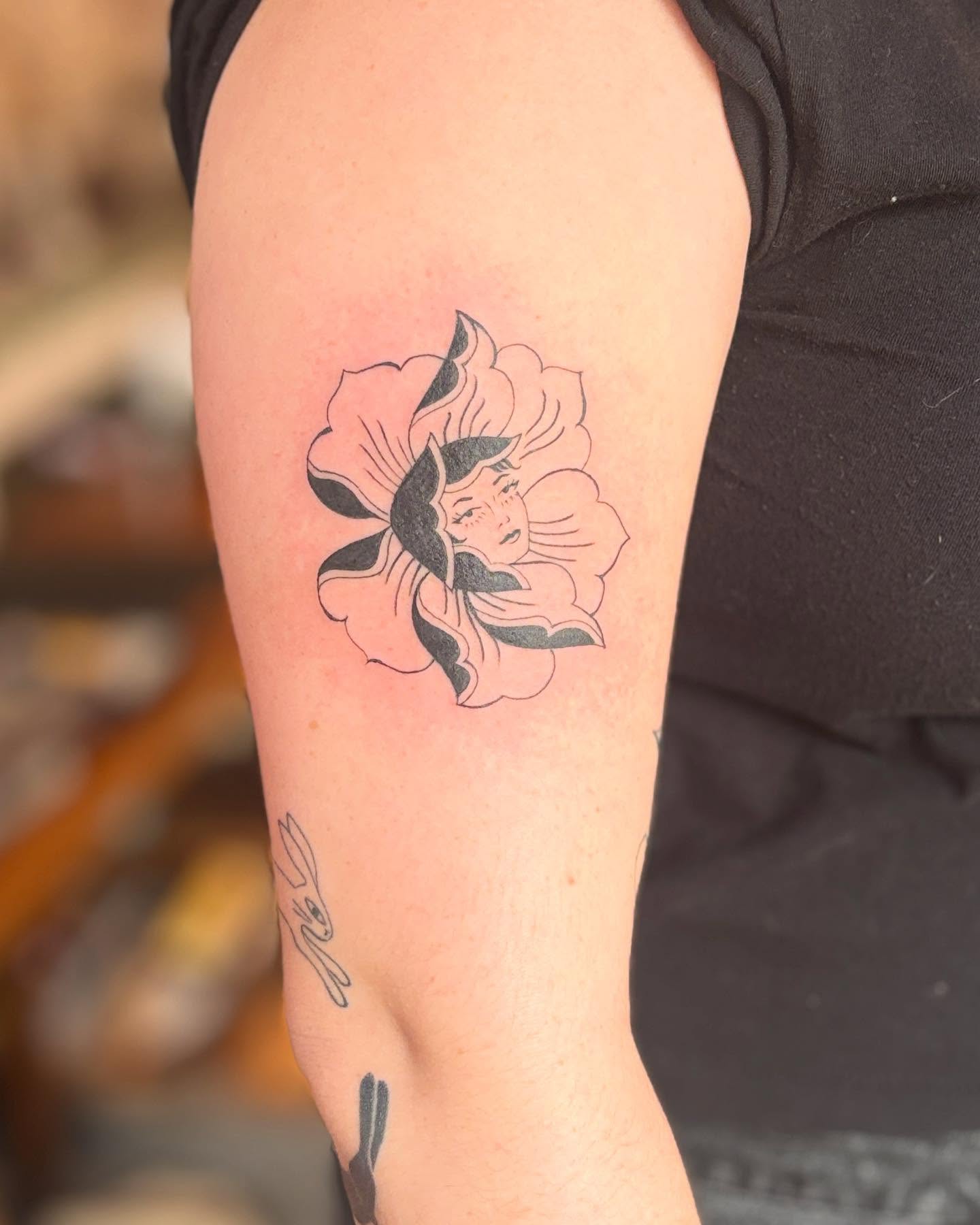 Flower with woman's face American traditional tattoo on the forearm by Reba Slate