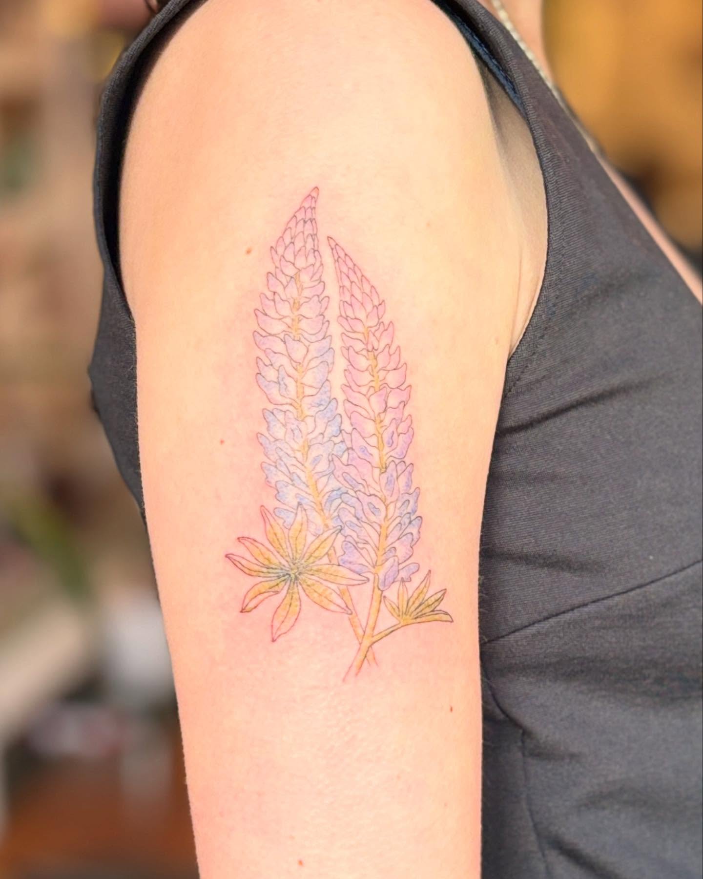 Lupine flowers watercolor tattoo on the forearm by Reba Slate