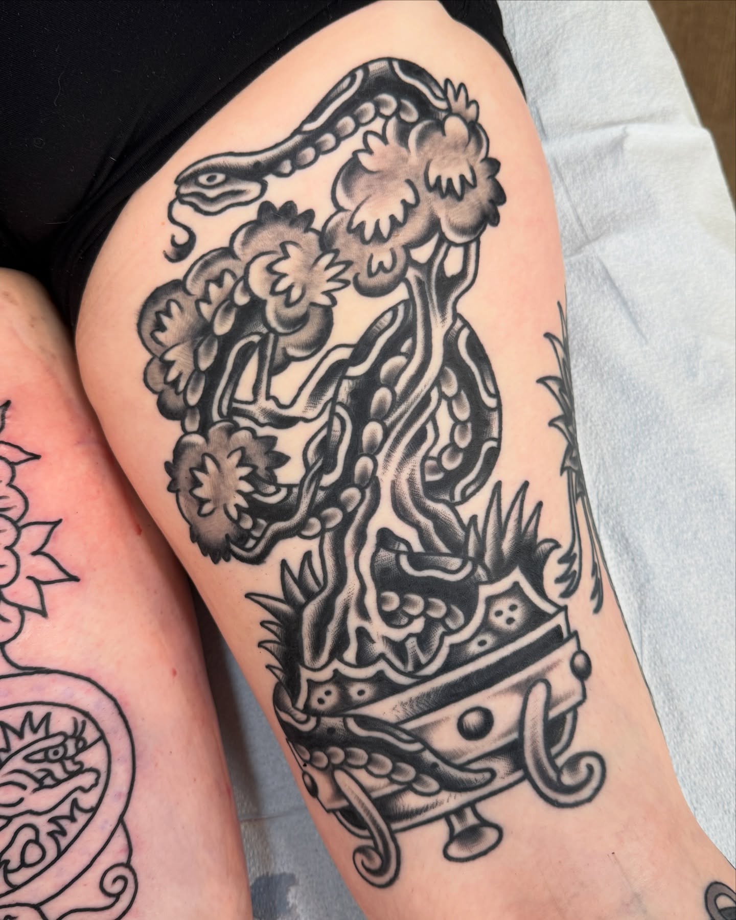Dragon and tree American traditional tattoo on the thigh by Cullen Bleser Quinn