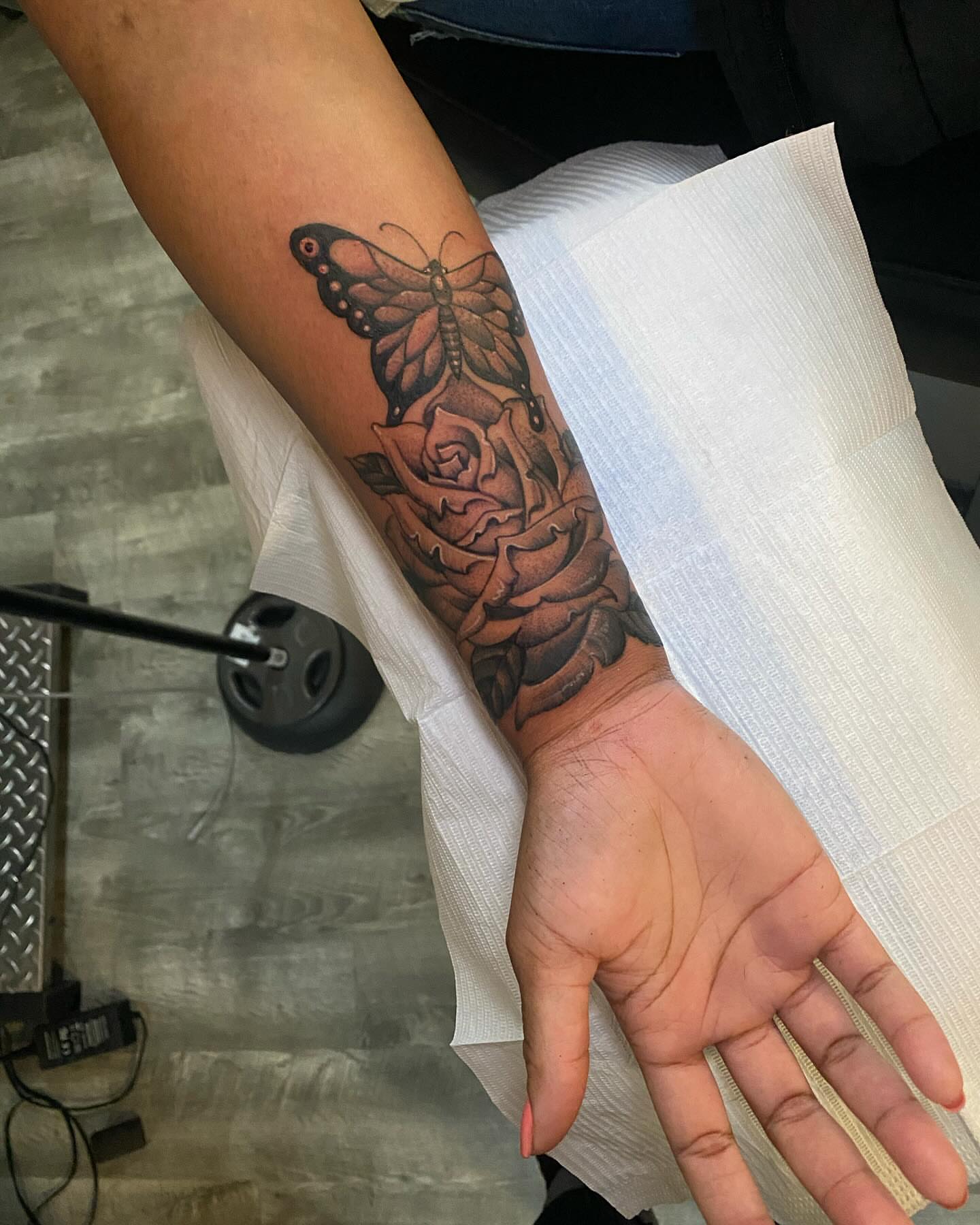 Butterfly and rose realism tattoo on the forearm by Chase Skylar Clayton Ogle