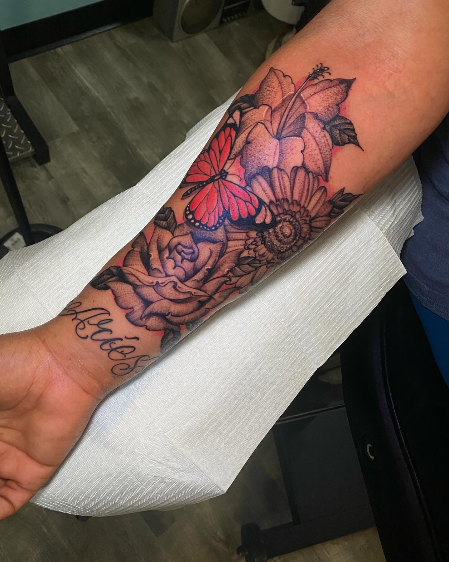 Flowers and butterfly realism tattoo on the forearm by Chase Skylar Clayton Ogle