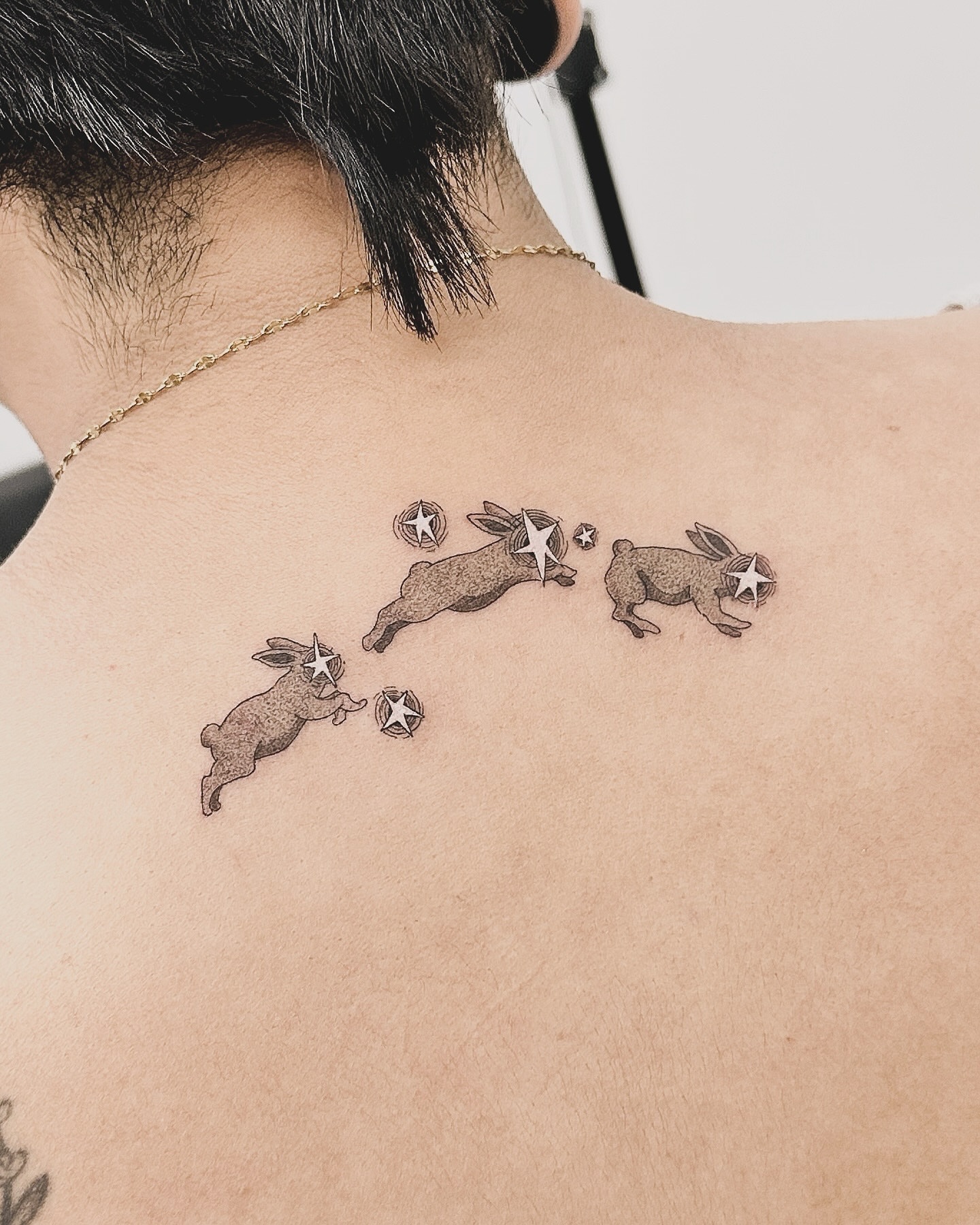 Rabbits black and grey tattoo on the back by p o b i