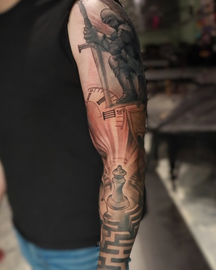 Sword and knight realism tattoo on the forearm by Mike j tattooer