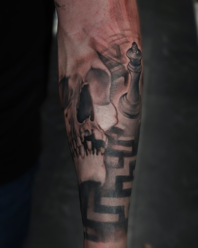 Skull and chess piece realism tattoo on the forearm by Mike j tattooer