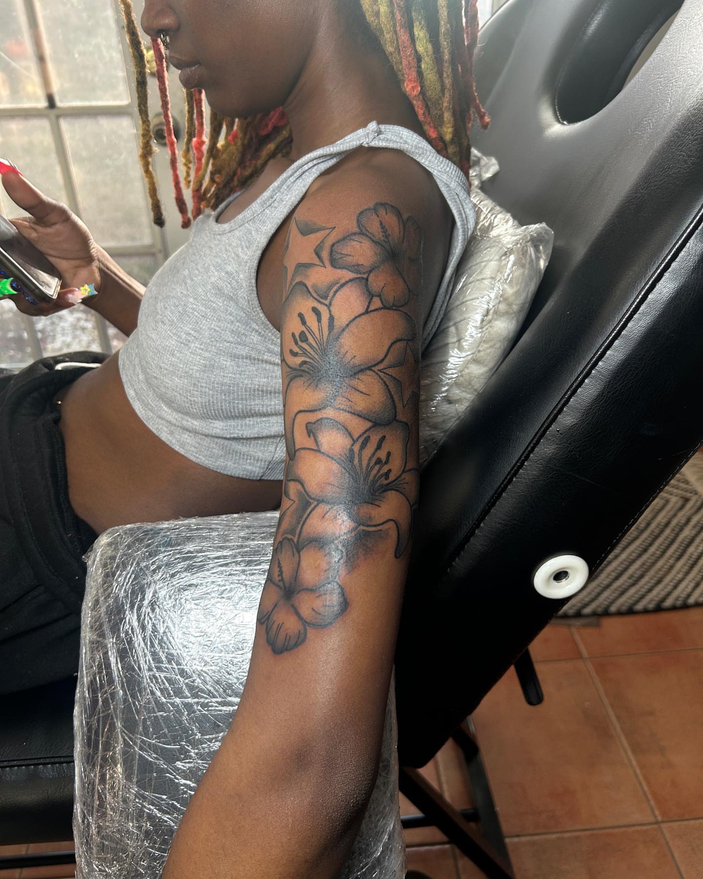 Flowers black and grey tattoo on the forearm by nylachanel