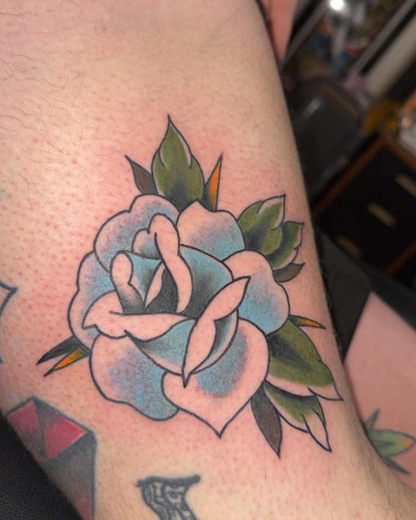 Rose American traditional tattoo on the forearm by Robbie Roberson