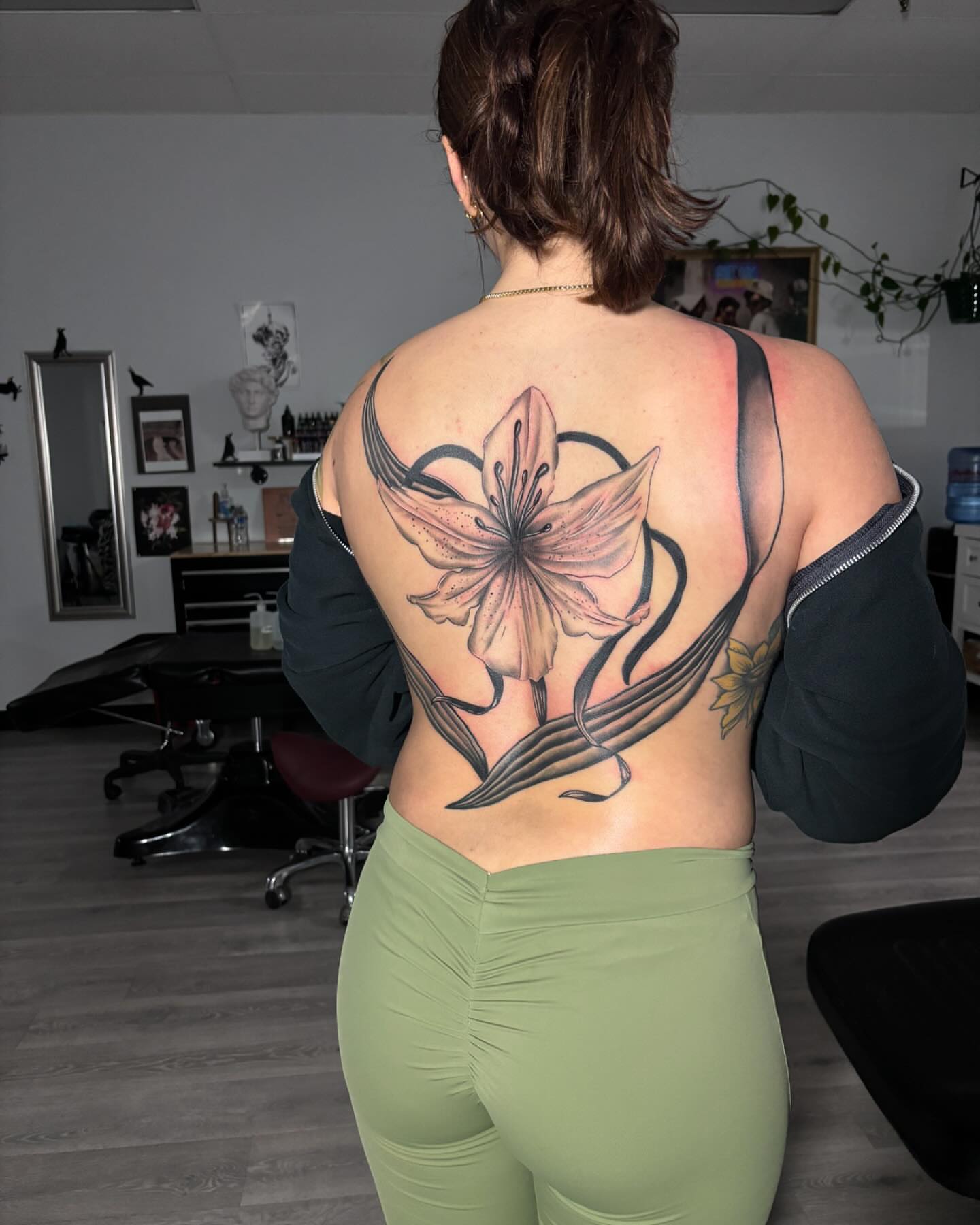 Lily realism tattoo on the back by Alyssa Turner