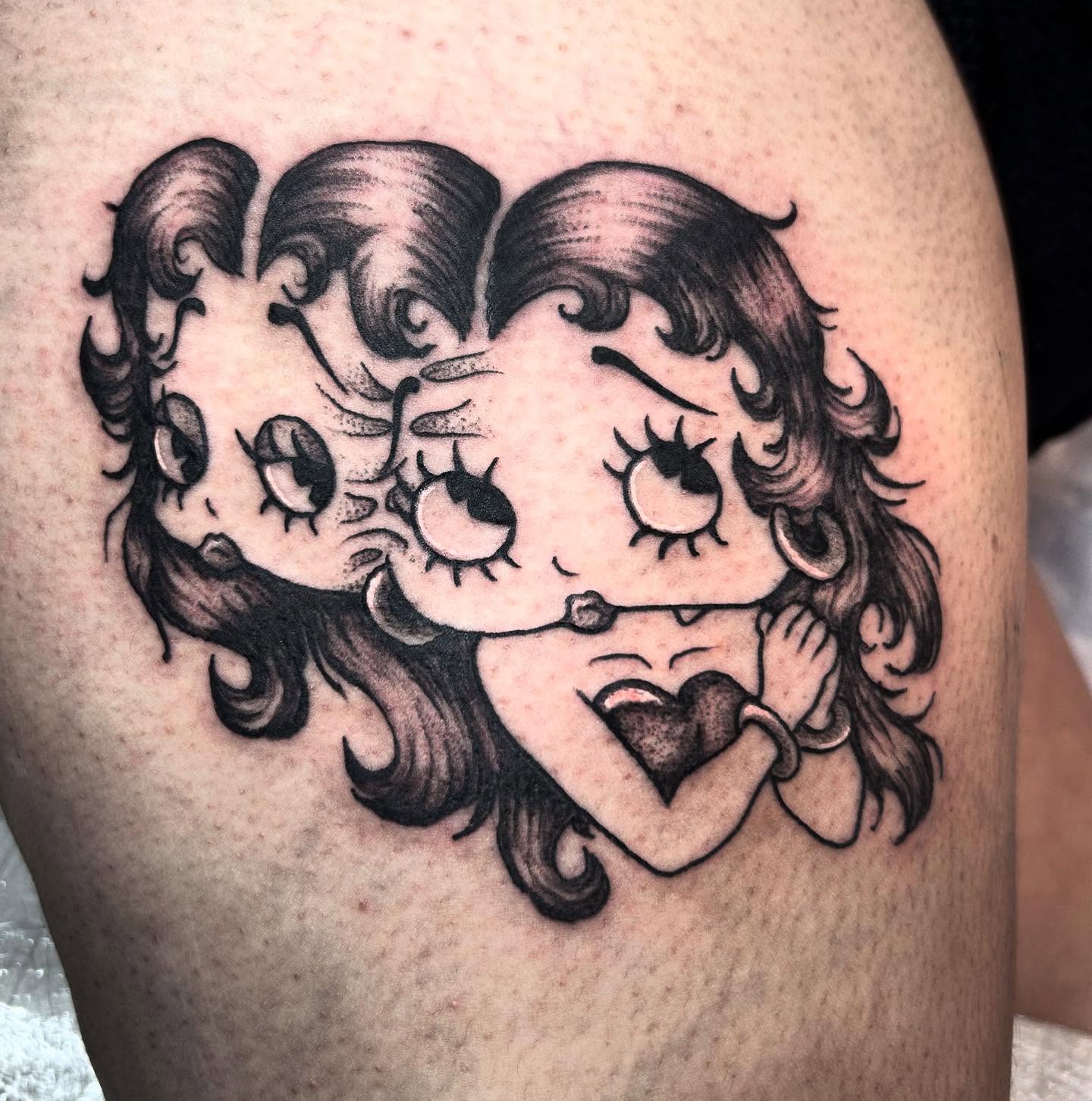 Betty Boop black and grey tattoo on the thigh by Nikki Power