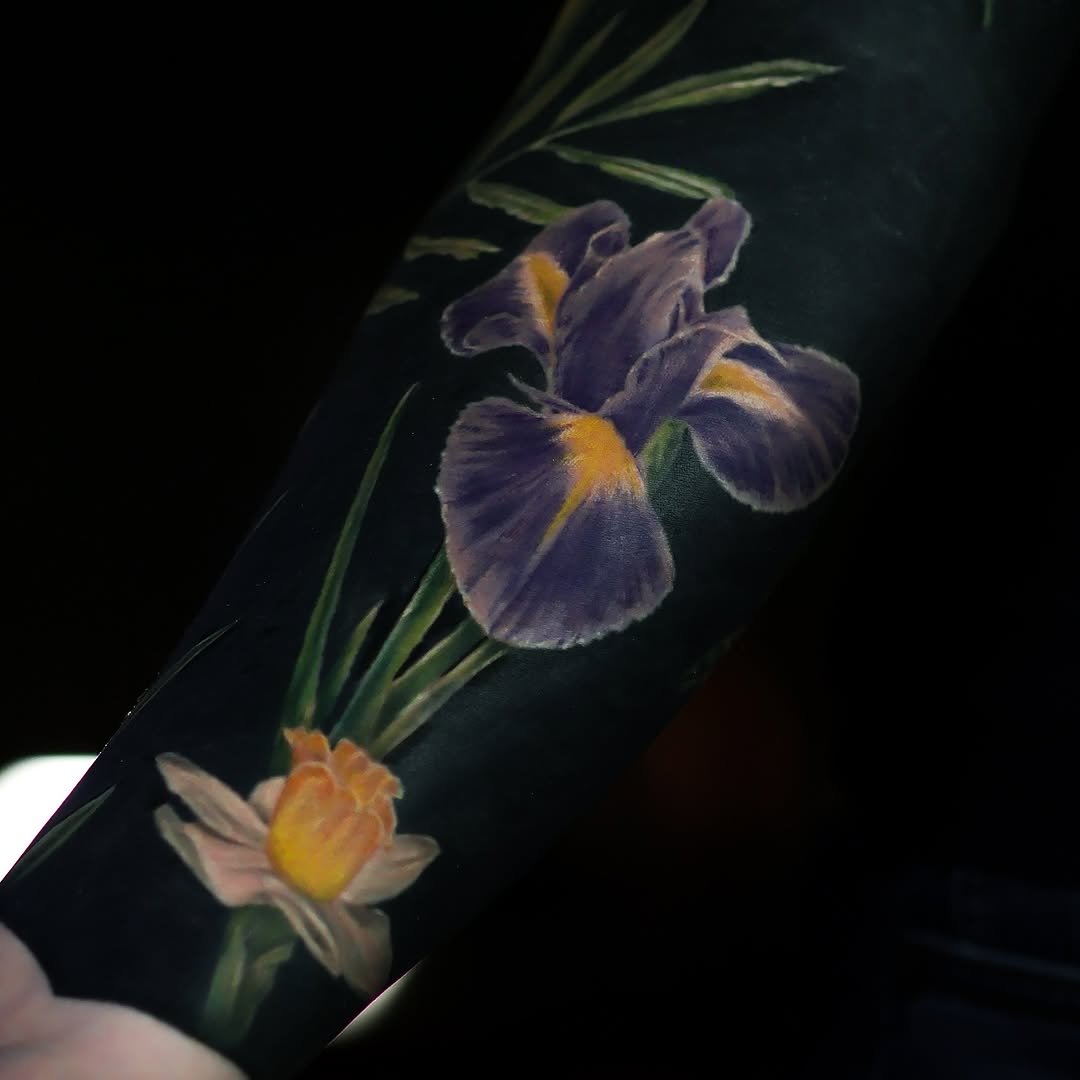 Iris and daffodil flowers fine line tattoo on the forearm by Felipe Andrade