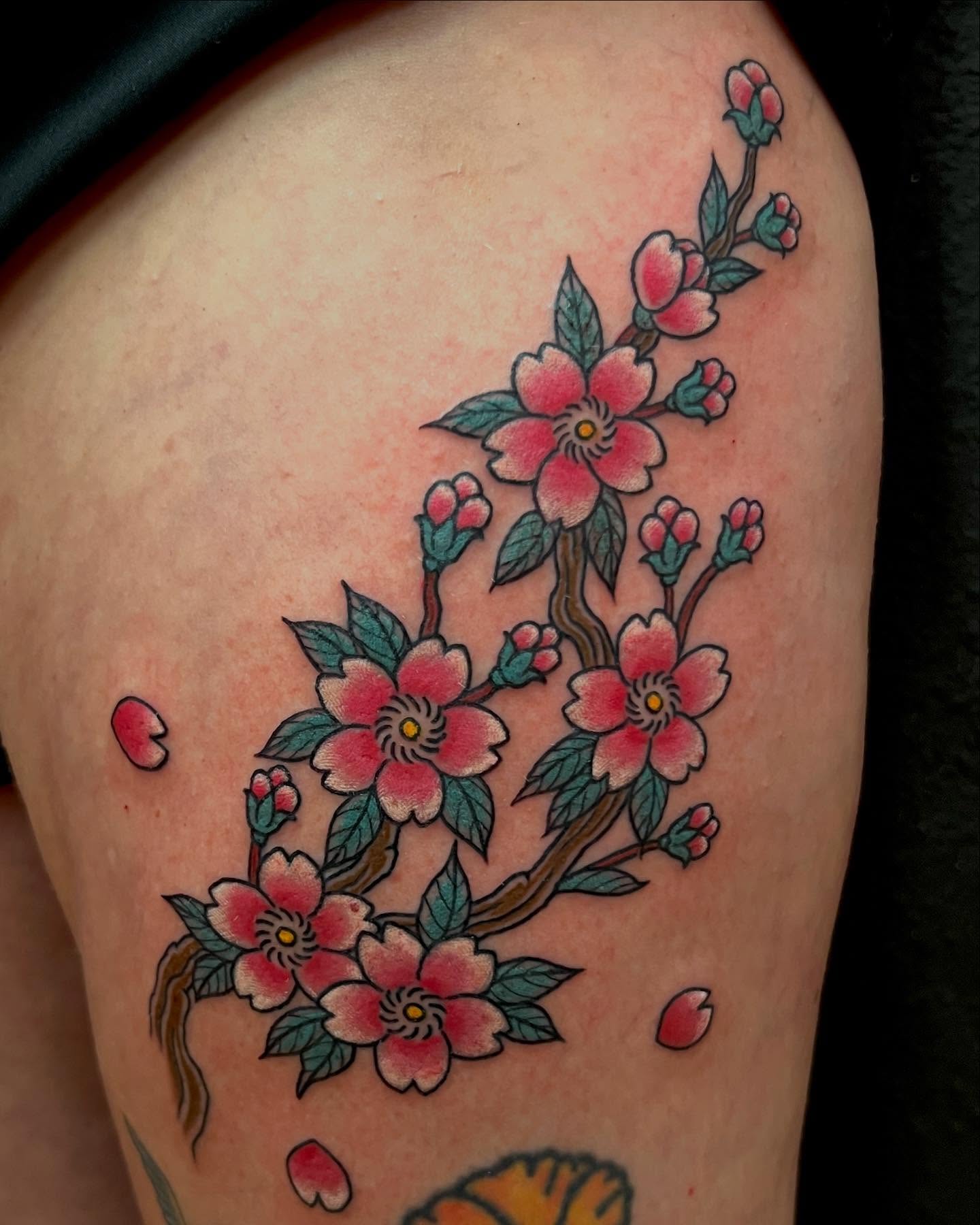 Cherry blossoms American traditional tattoo on the thigh by Rocky Burley, Georgetown, Texas