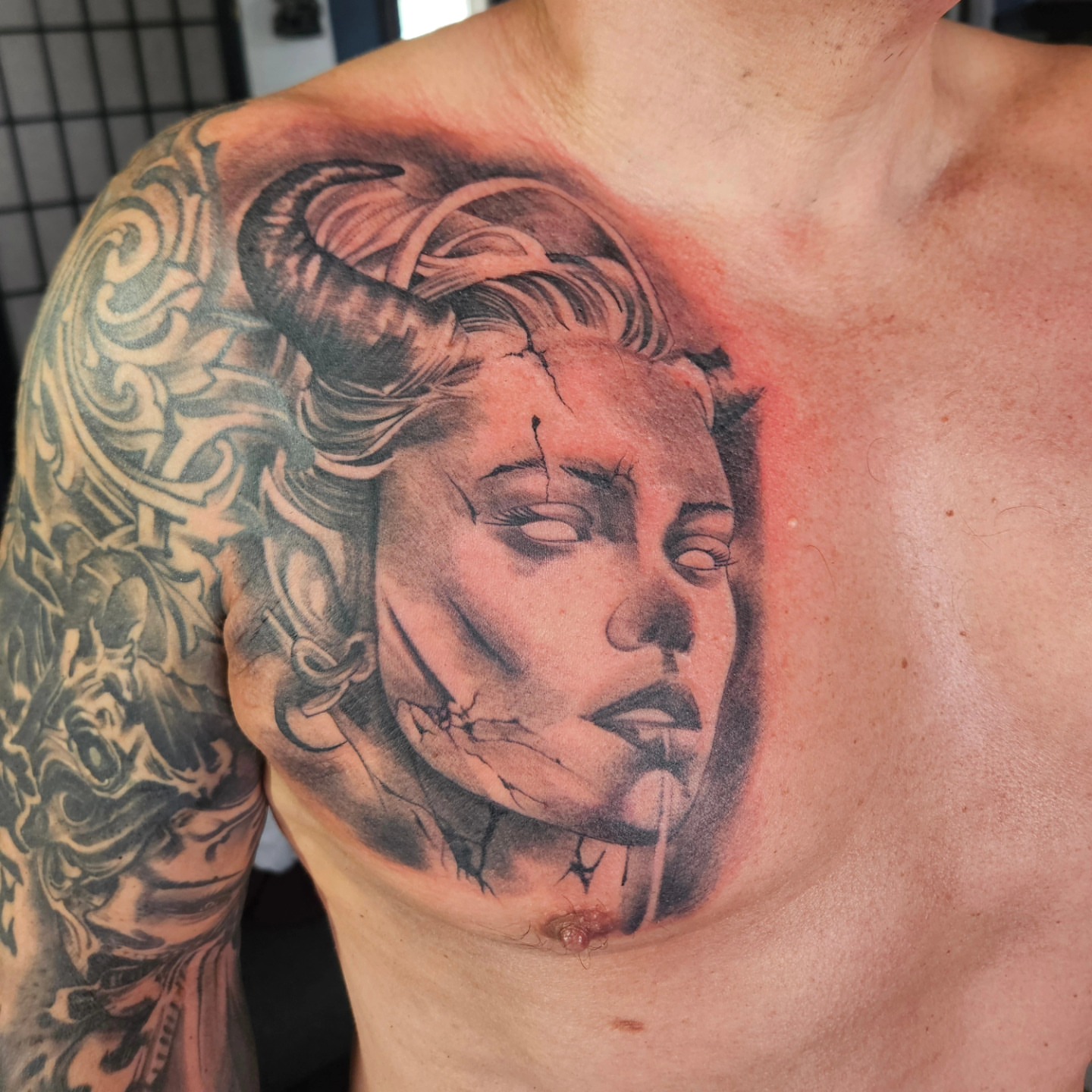 Woman's face realism tattoo on the chest by German Romero-Rendon