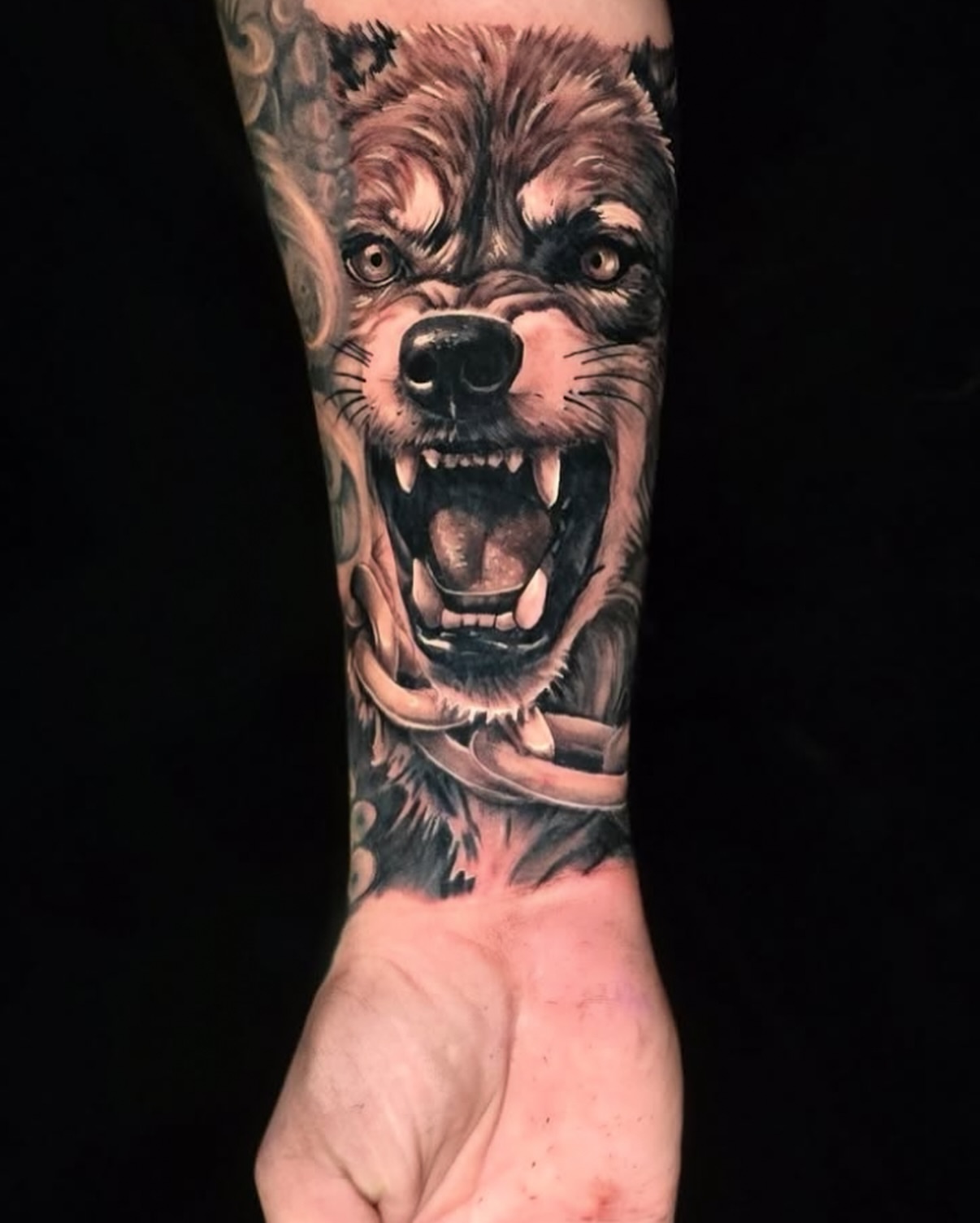 Wolf realism tattoo on the forearm by Myth & Mercy Tattoo Co.