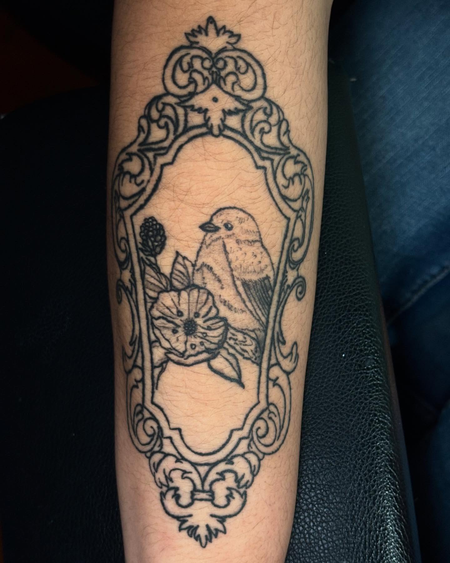 Bird and flower ornamental tattoo on the forearm by Angel Arceo