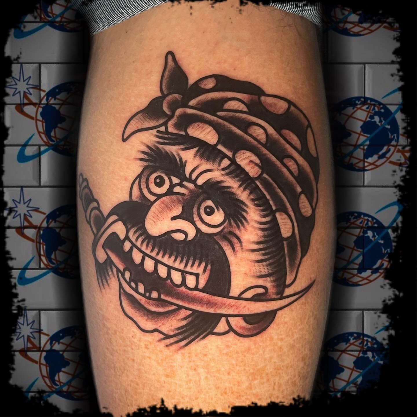 Japanese mask American traditional tattoo on the thigh by Antonio DeCaro