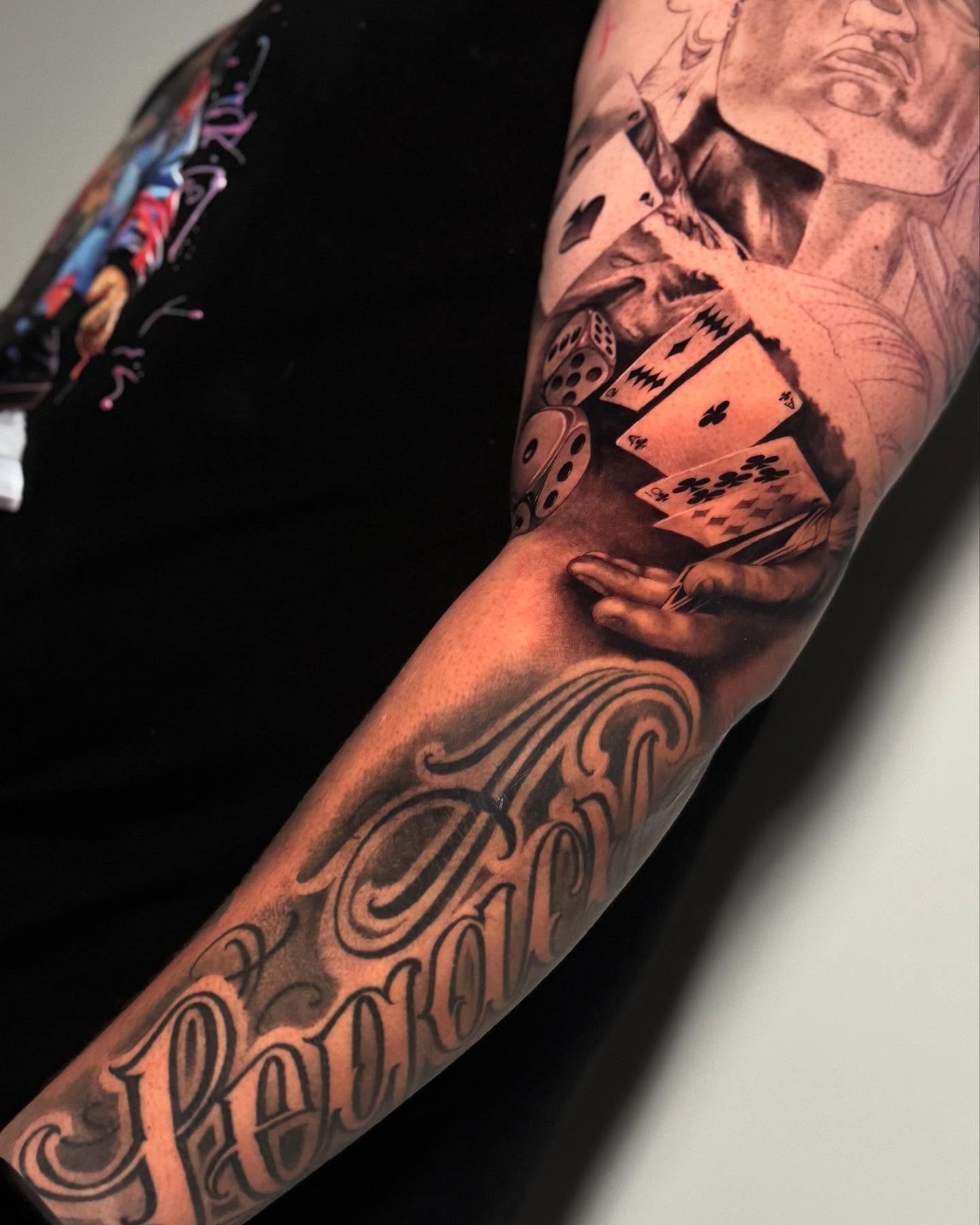 Playing cards and dice realism tattoo on the forearm by Sena Sim 🇰🇭, Worcester, Massachusetts