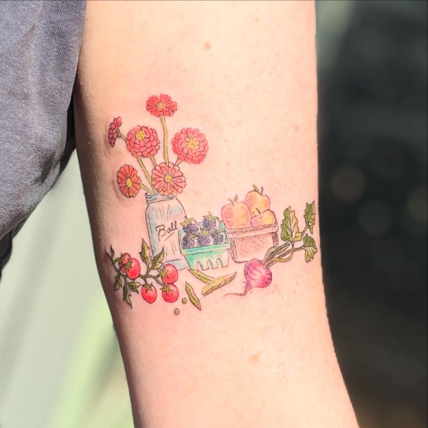 Flowers and vegetables watercolor tattoo on the forearm by Reba Slate