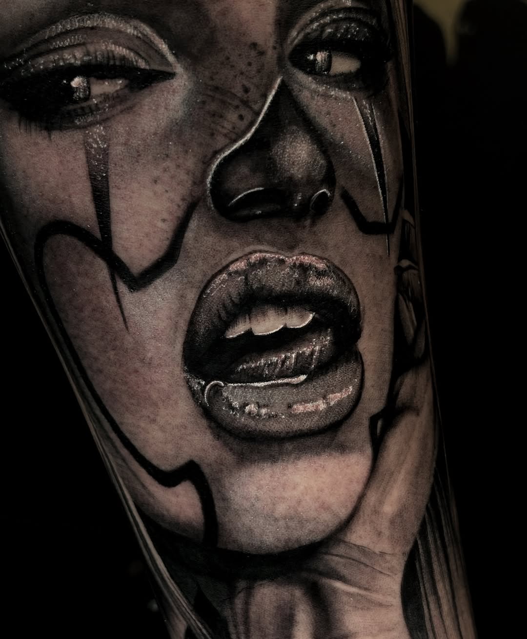 Clown face portrait Chicano tattoo on the forearm by Alejo Ibanez Tattoo