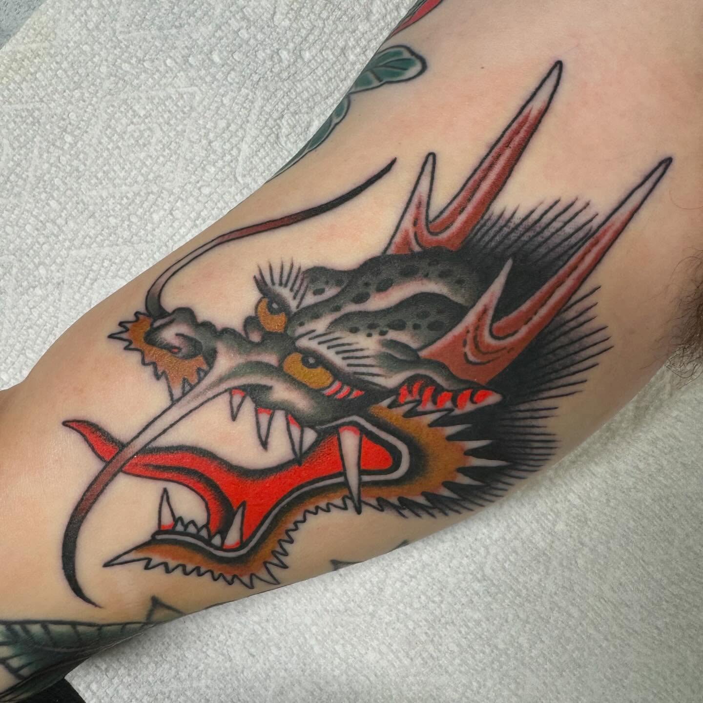 Dragon American traditional tattoo on the forearm by Sean McMahon