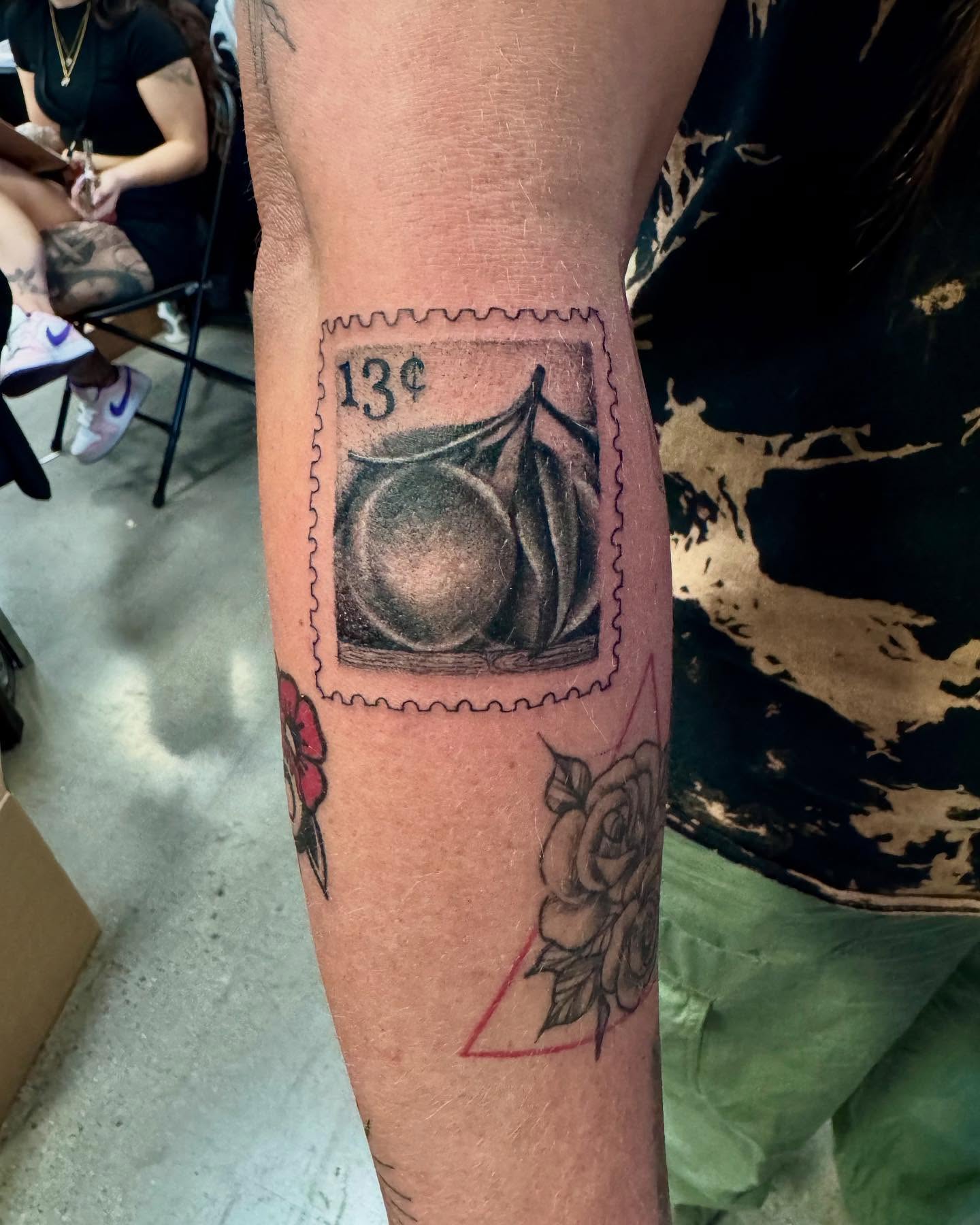 Postage stamp black and grey tattoo on the forearm by Stephanie Cruz, Kansas City, Missouri