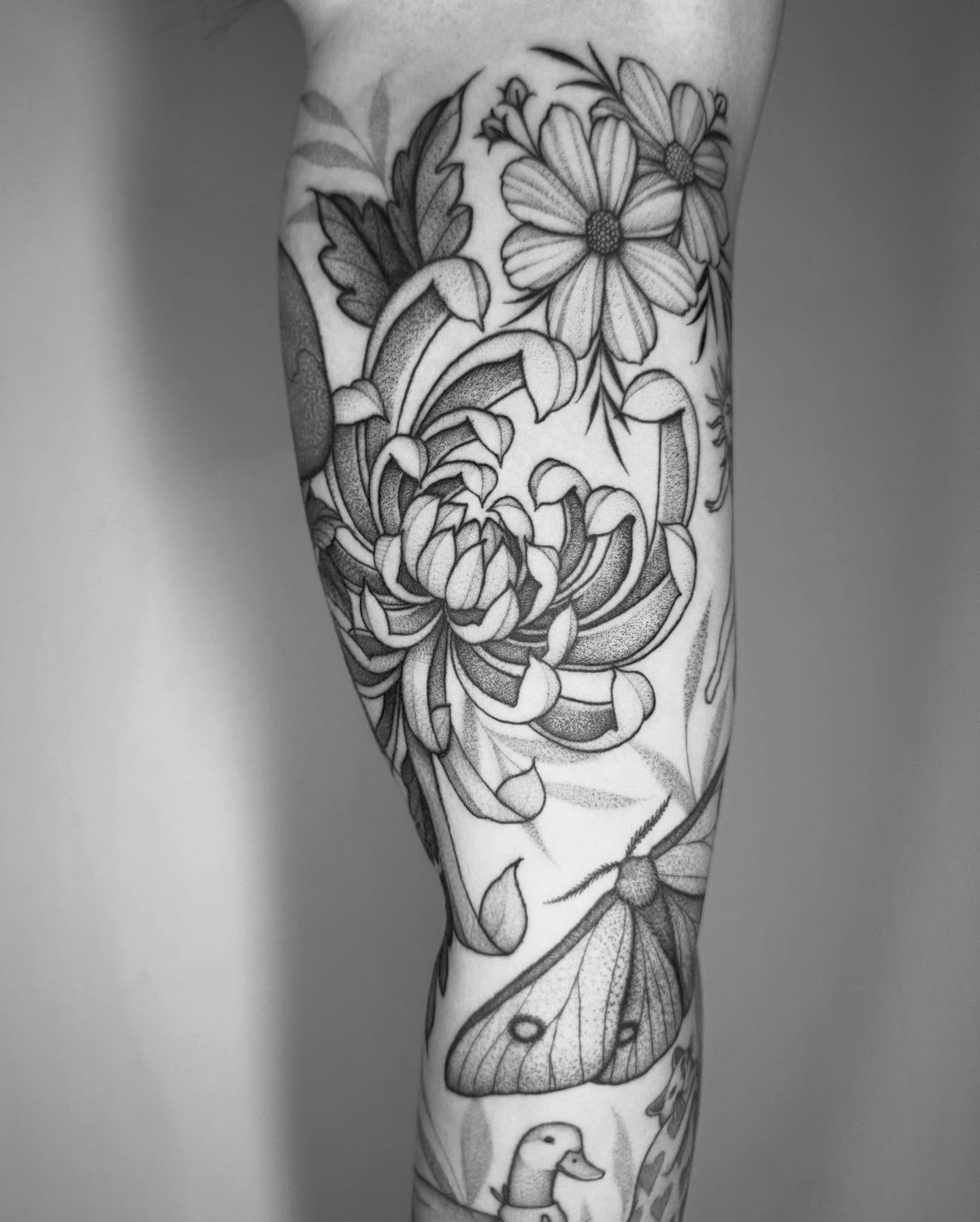 Flowers and moth dotwork tattoo on the forearm by Lauren Llerandi