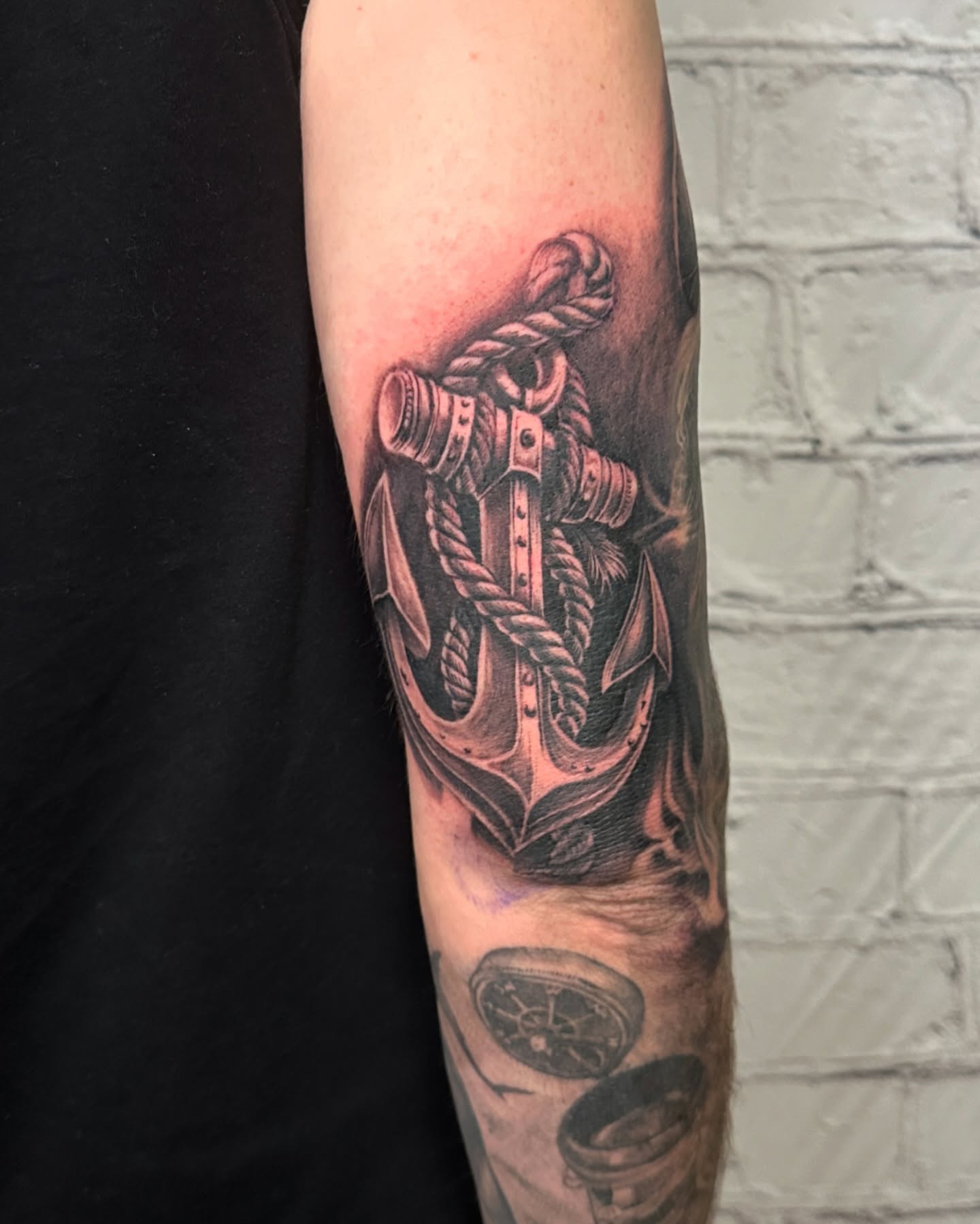 Anchor black and grey tattoo on the forearm by Stephen Hansen