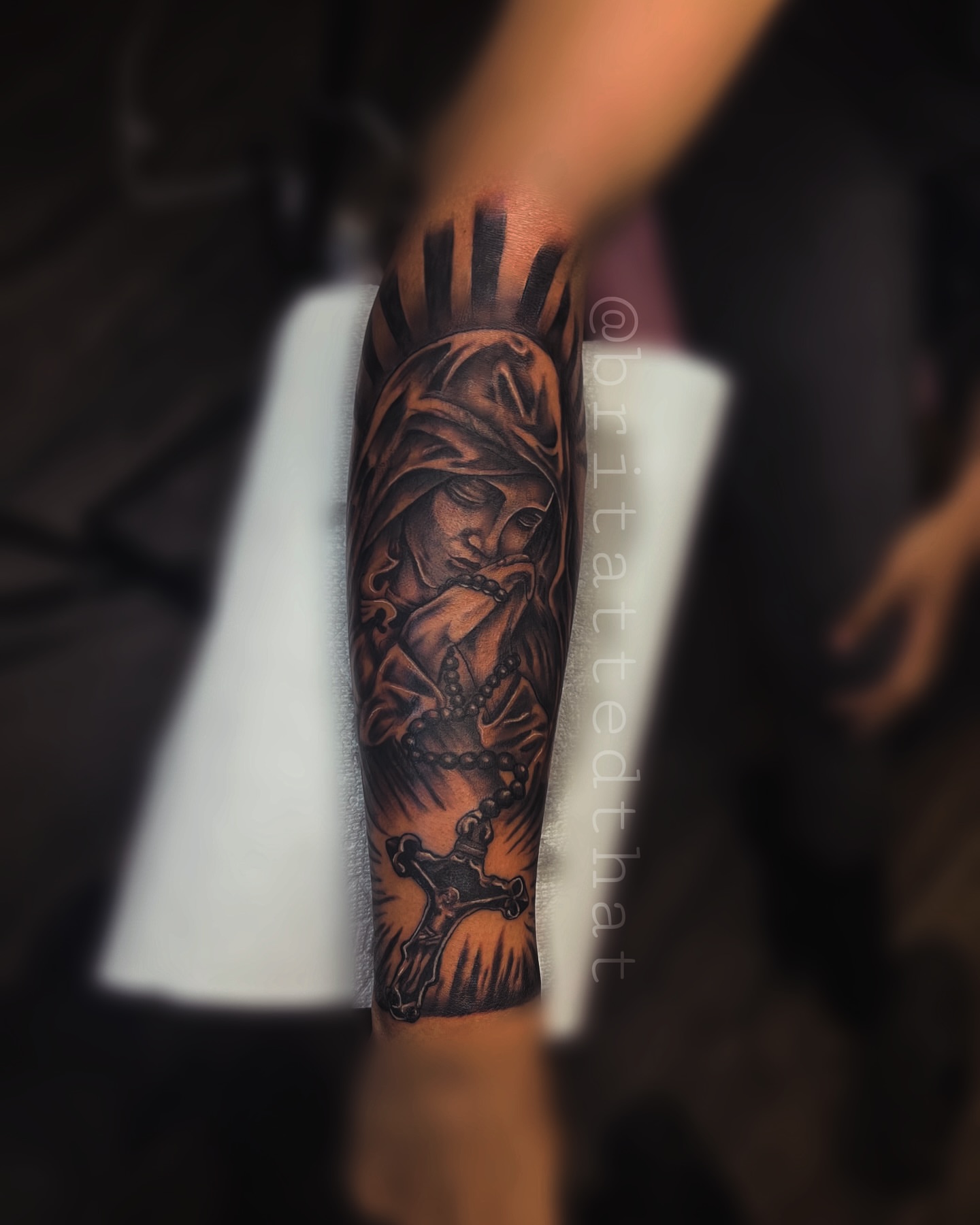 Religious figure with rosary realism tattoo on the forearm by Bri Tatted That