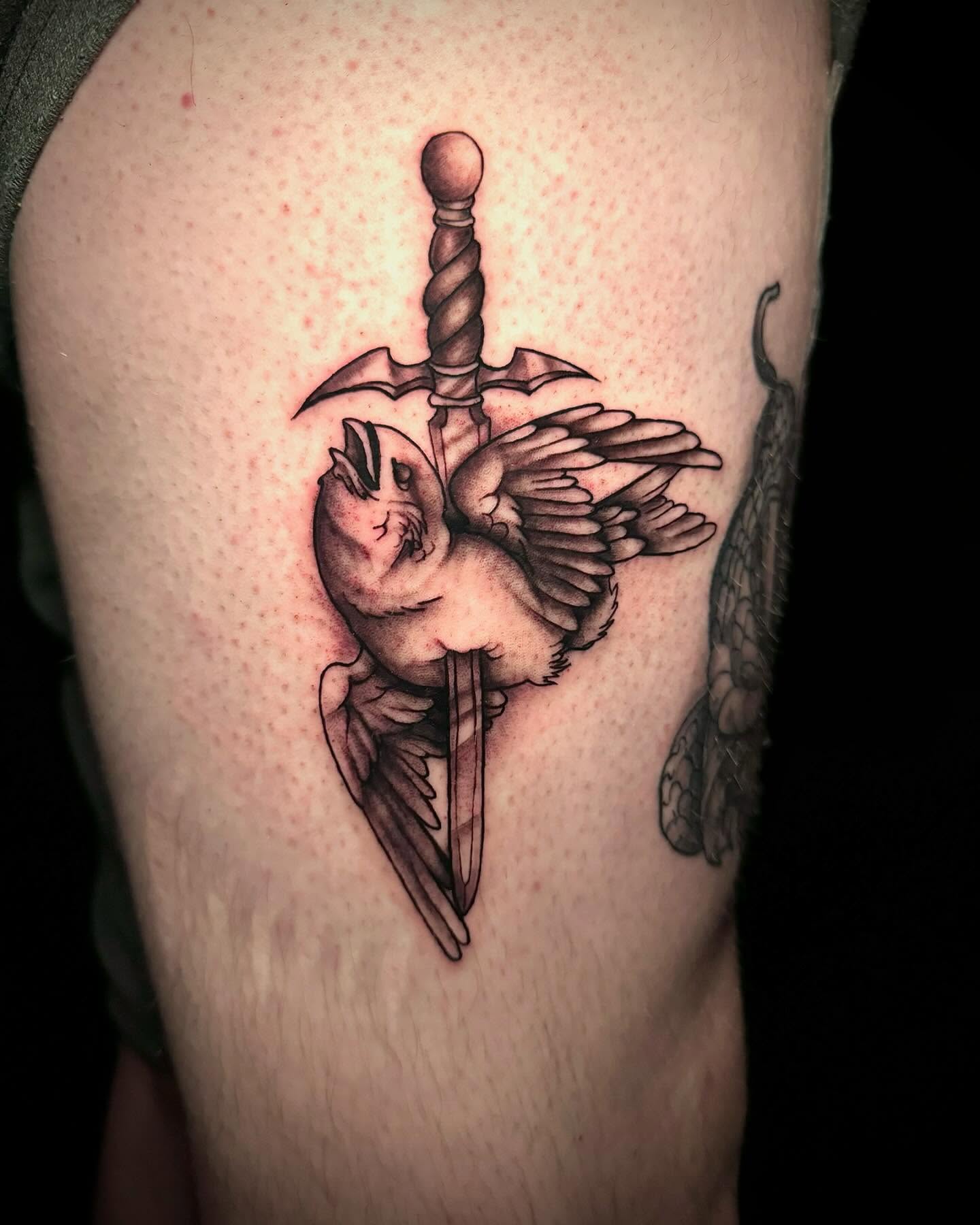 Bird and sword black and grey tattoo on the forearm by Ryland - Tattoo Artist