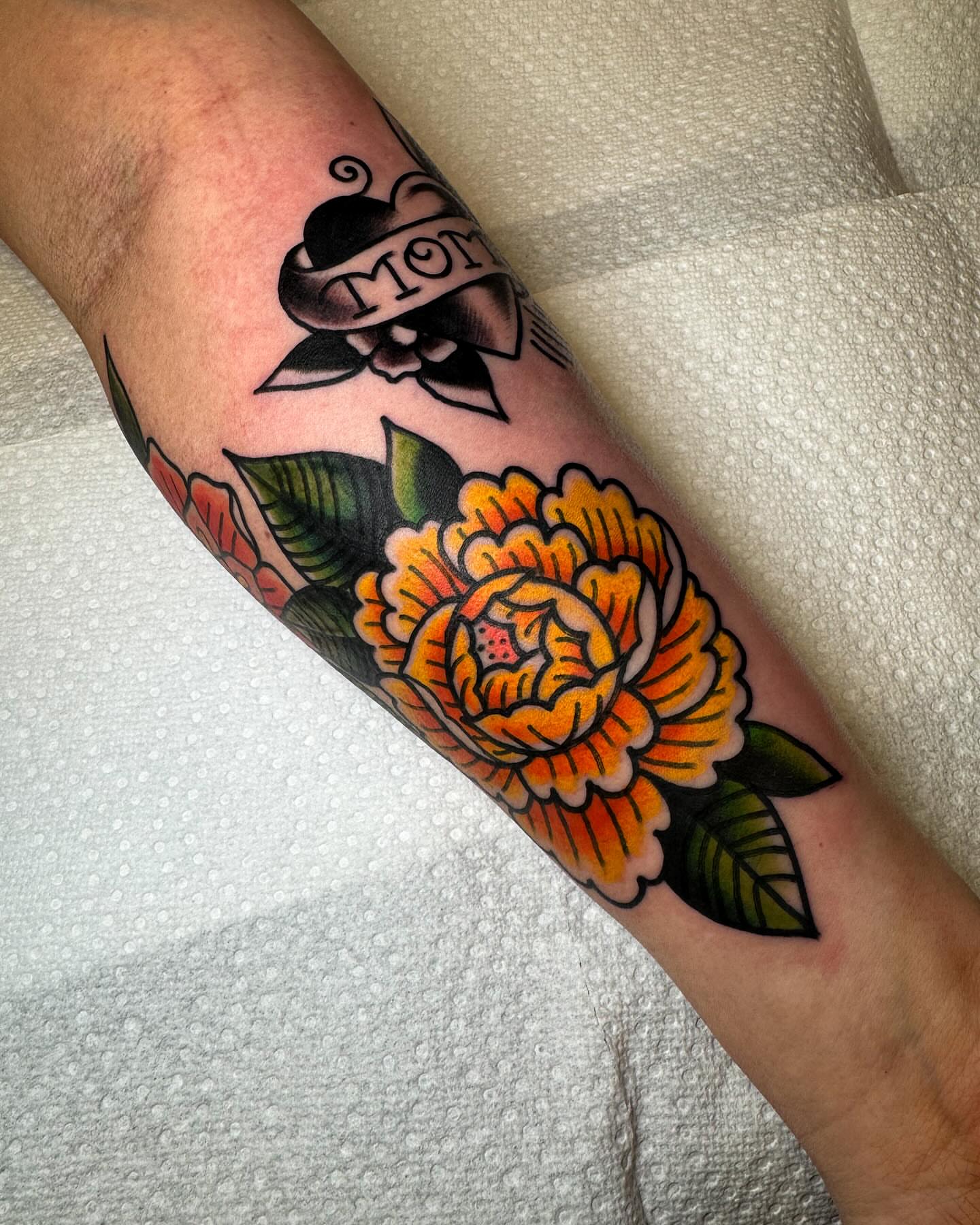 Orange flower American traditional tattoo on the forearm by Alex Kass 🥩 San Antonio TX, San Antonio, Texas