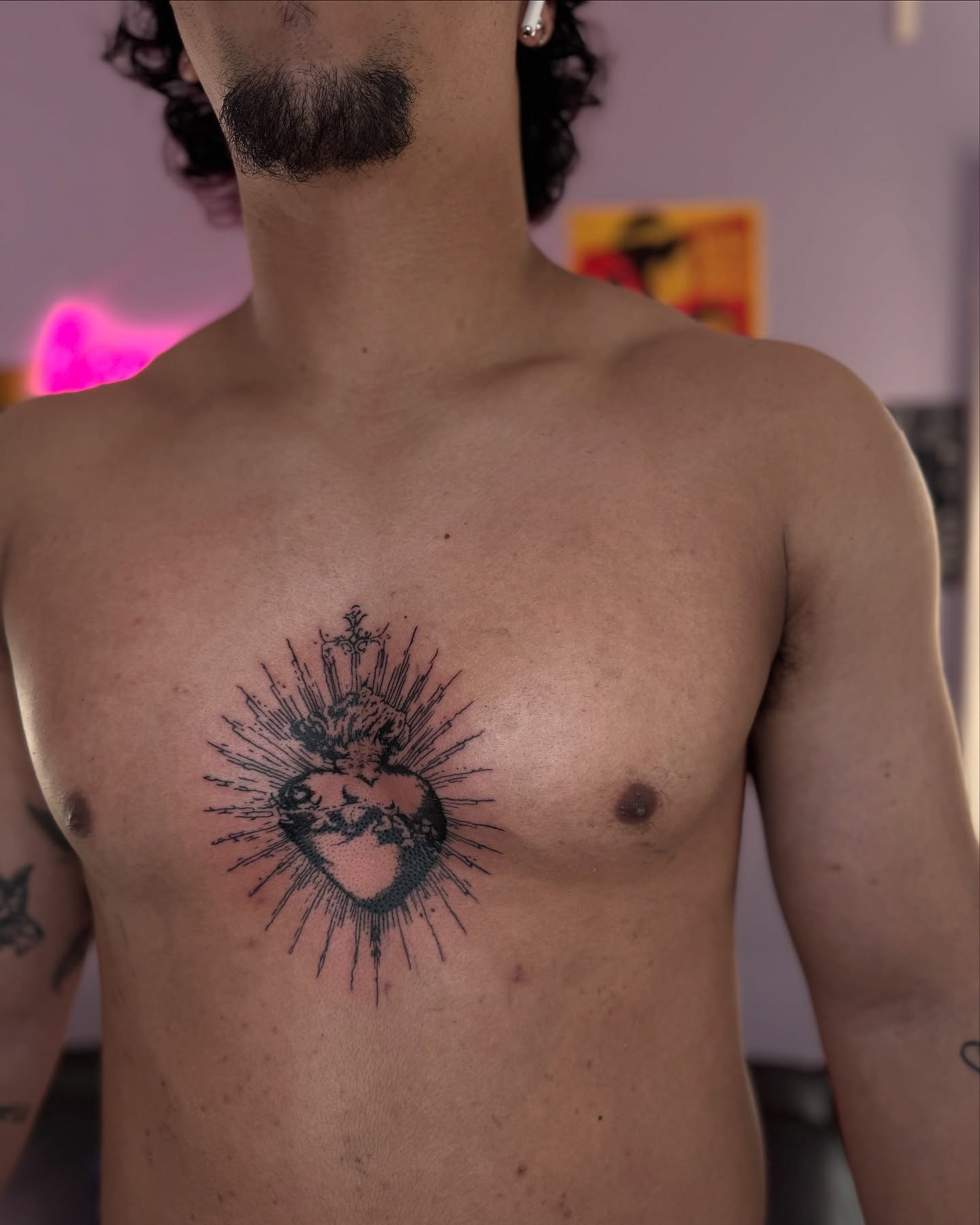 Heart with rays dotwork tattoo on the chest by Honey