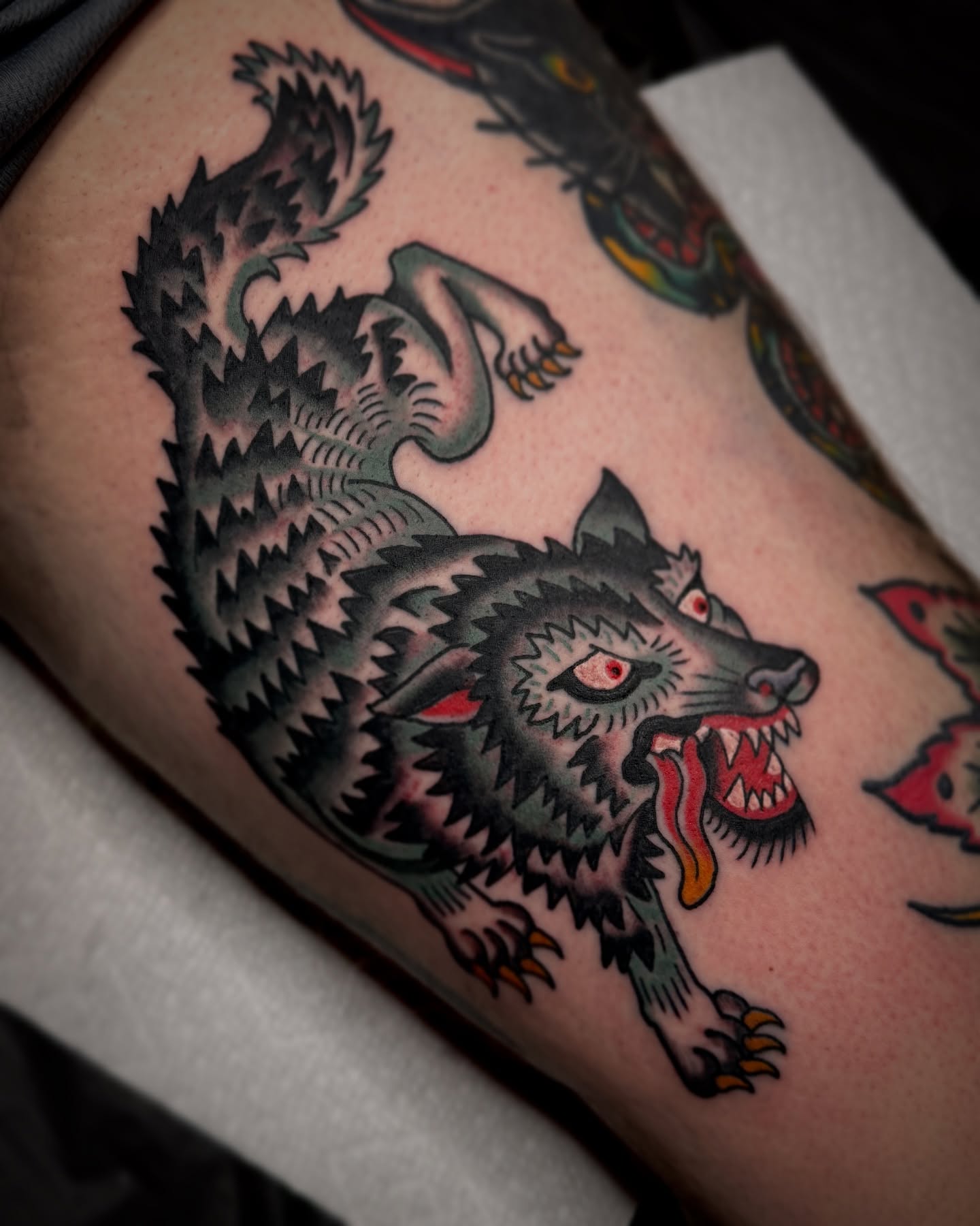 Wolf American traditional tattoo on the thigh by Drew McElveney, Austin, Texas