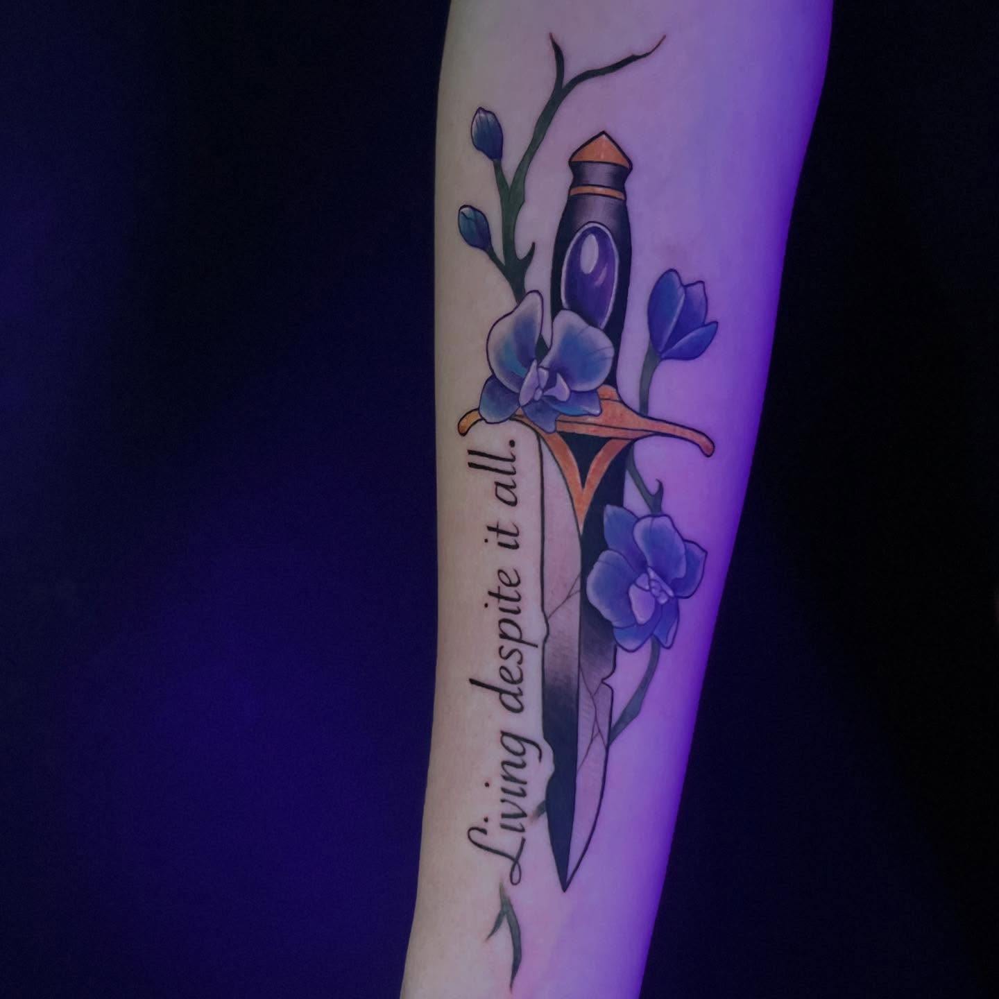Sword and flowers new school tattoo on the forearm by Lexi Ross