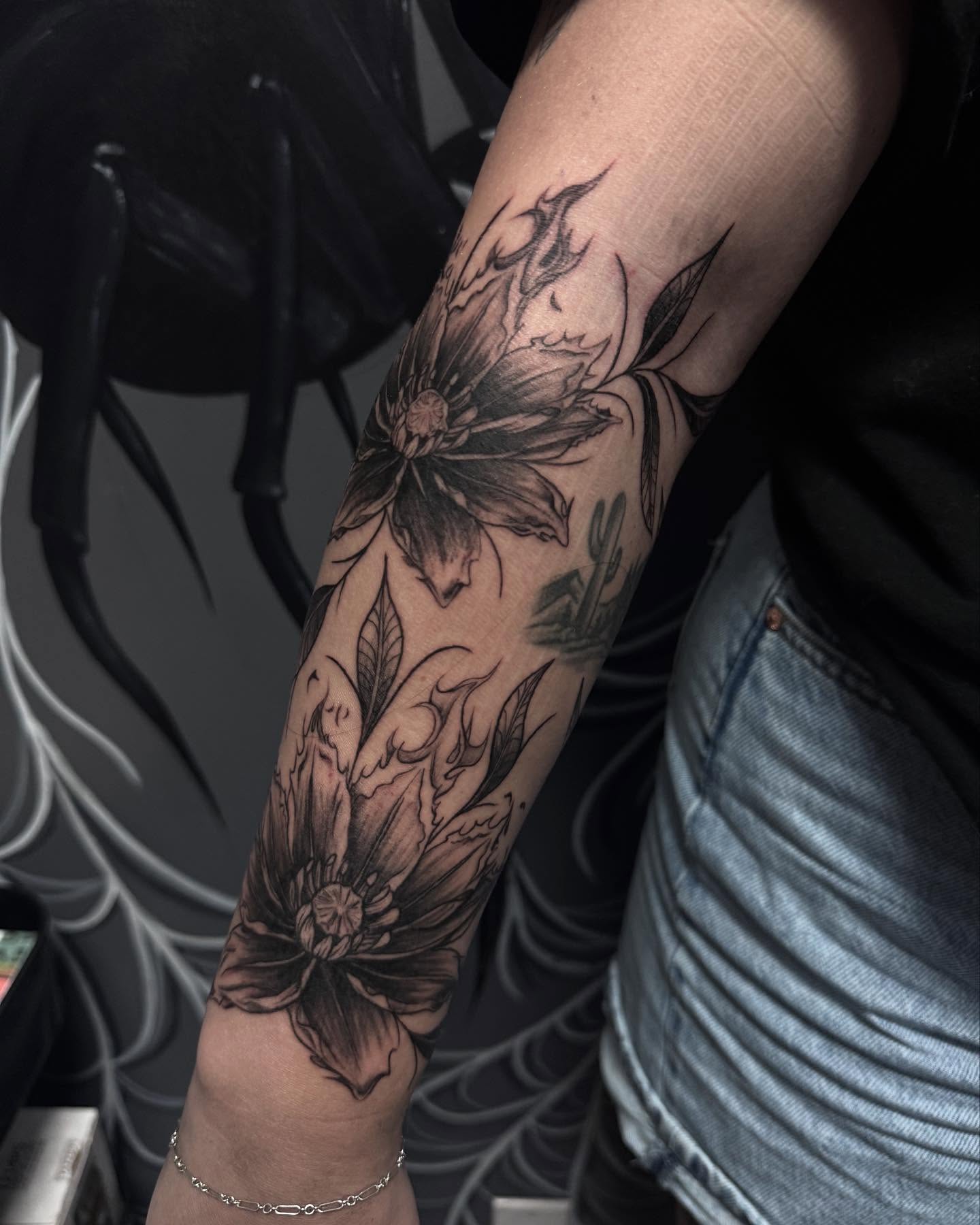 Floral bouquet black and grey tattoo on the forearm by Jianna