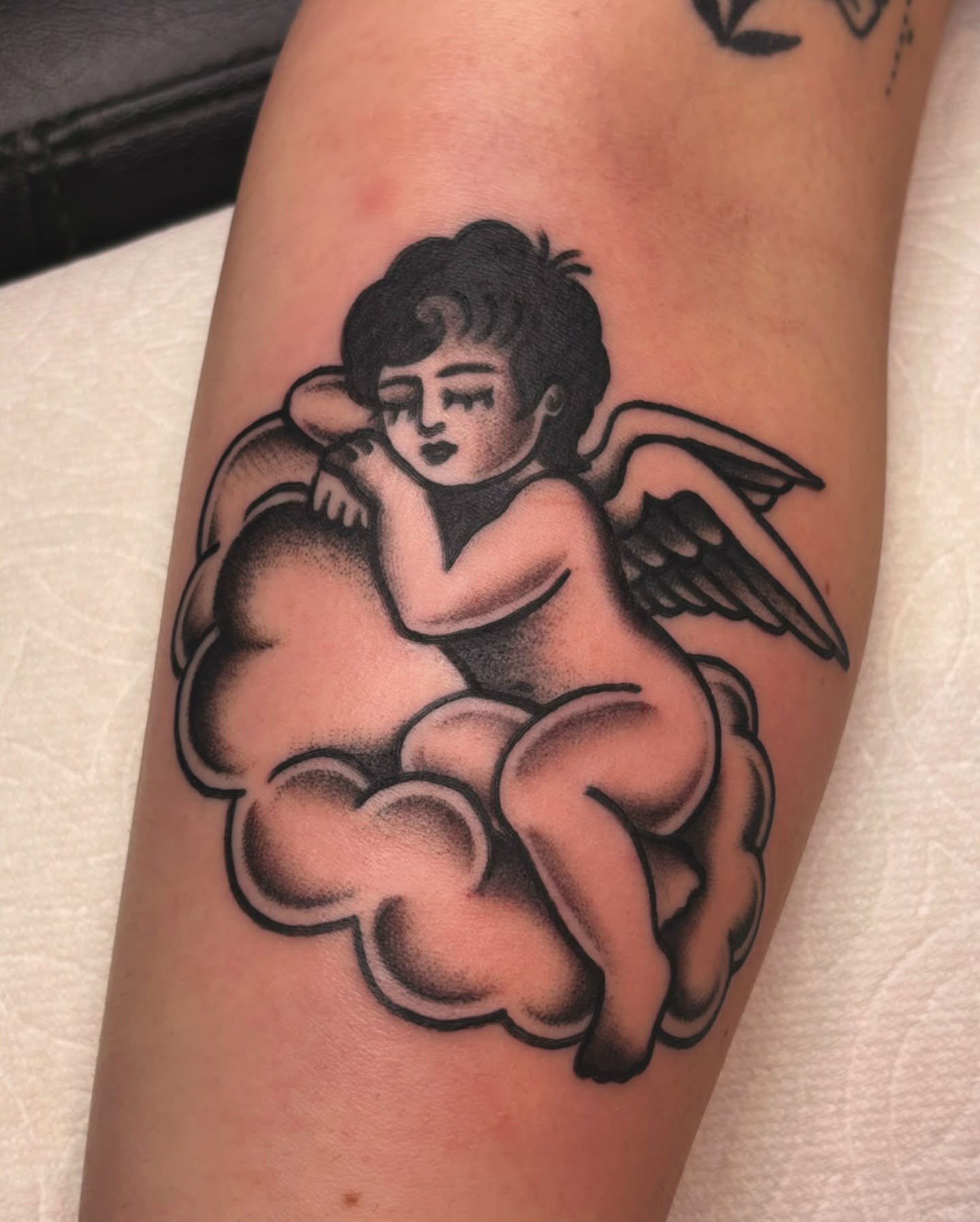 Cherub American traditional tattoo on the forearm by ๐๐๐ฏ๐ข๐ซ