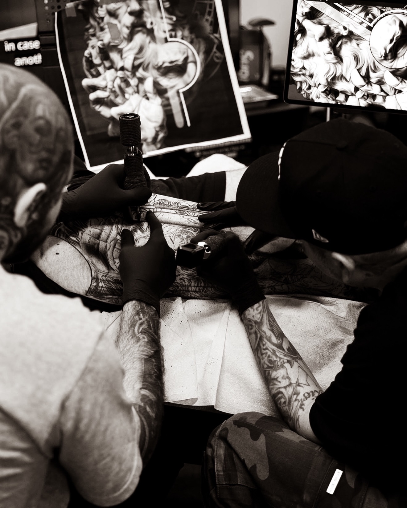 Floral design black and grey tattoo on the upper arm by Dillinger, Ventura, California