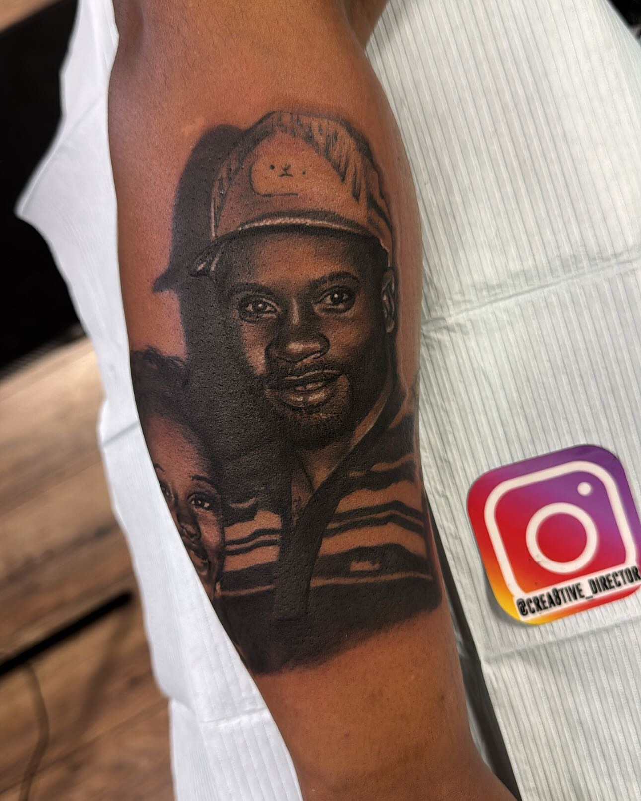 Portrait realism tattoo on the forearm by Cedric Fleming