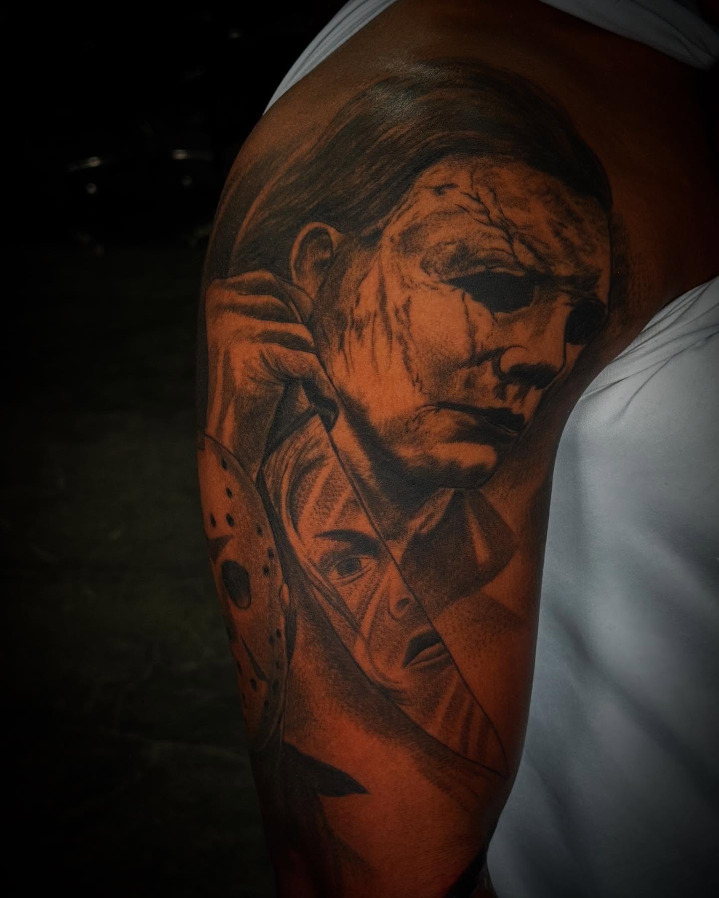 Mask and knife dotwork tattoo on the upper arm by Carlos Lujan