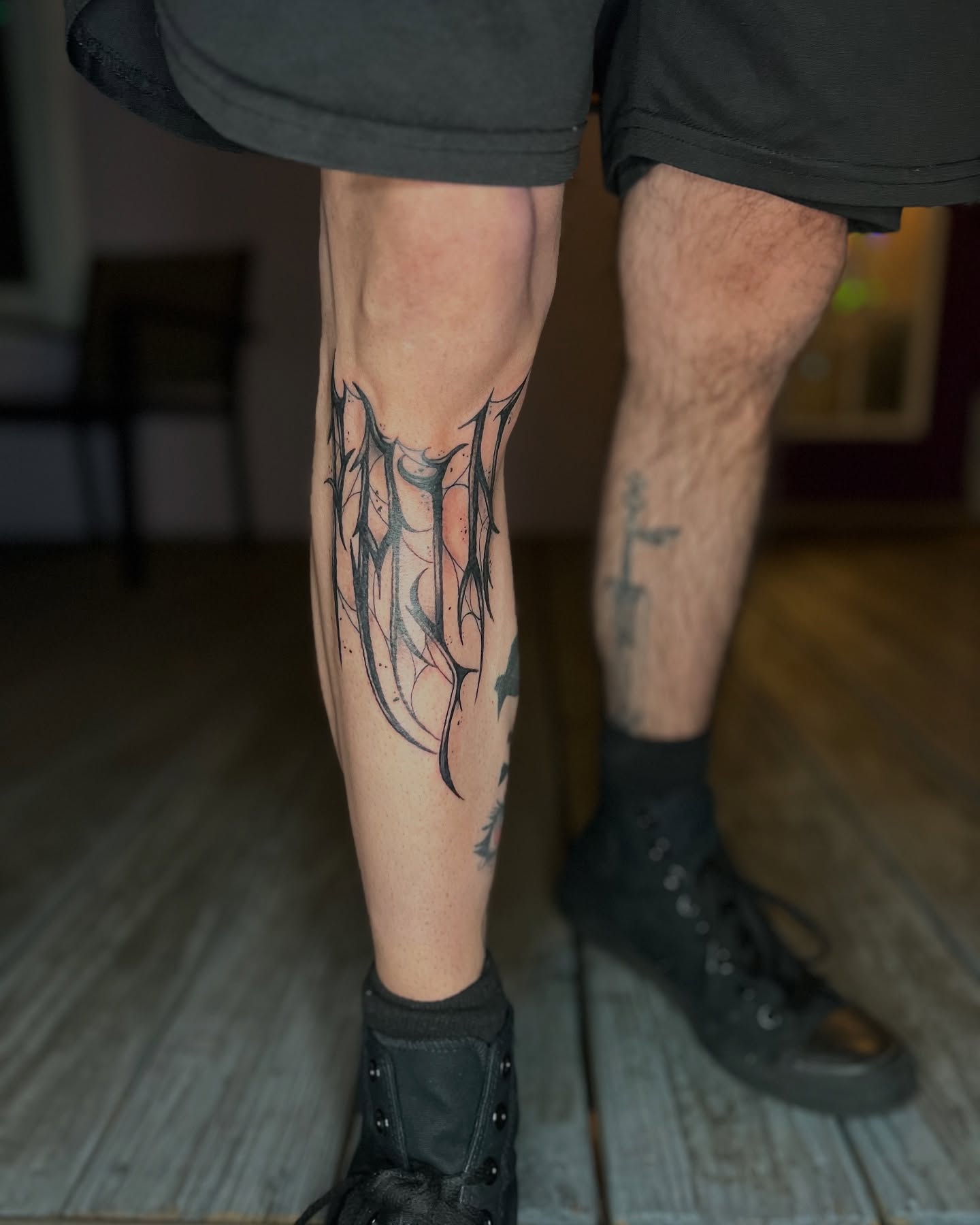 Wing black and grey tattoo on the calf by Rose DeLisse