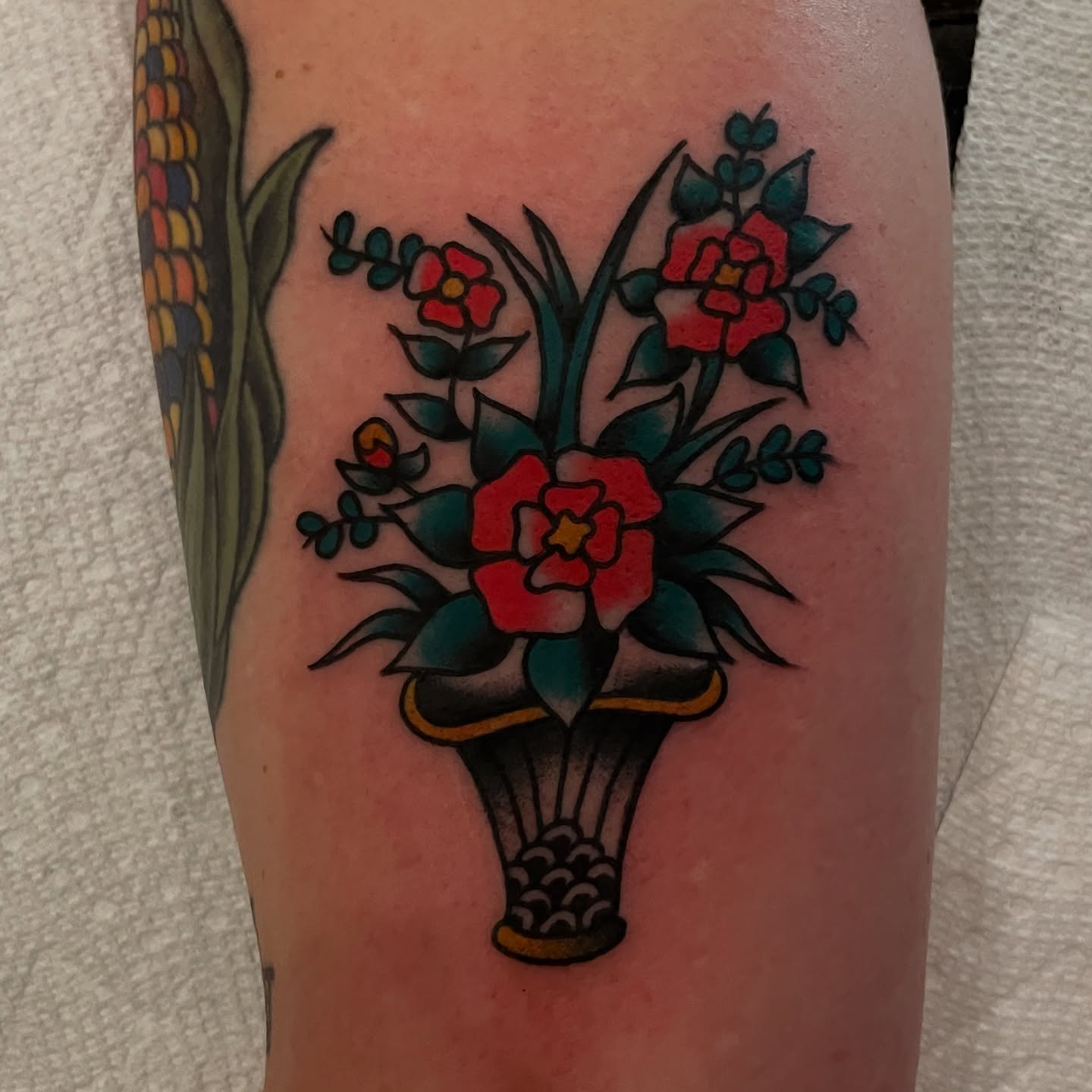 Flower bouquet American traditional tattoo on the thigh by Texas Jonah