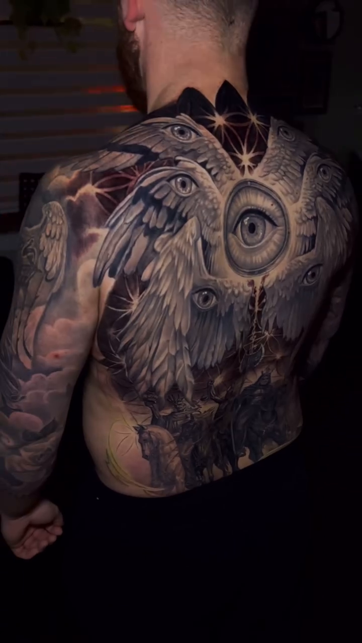 Angelic figure with multiple eyes realism tattoo by Abel Deida