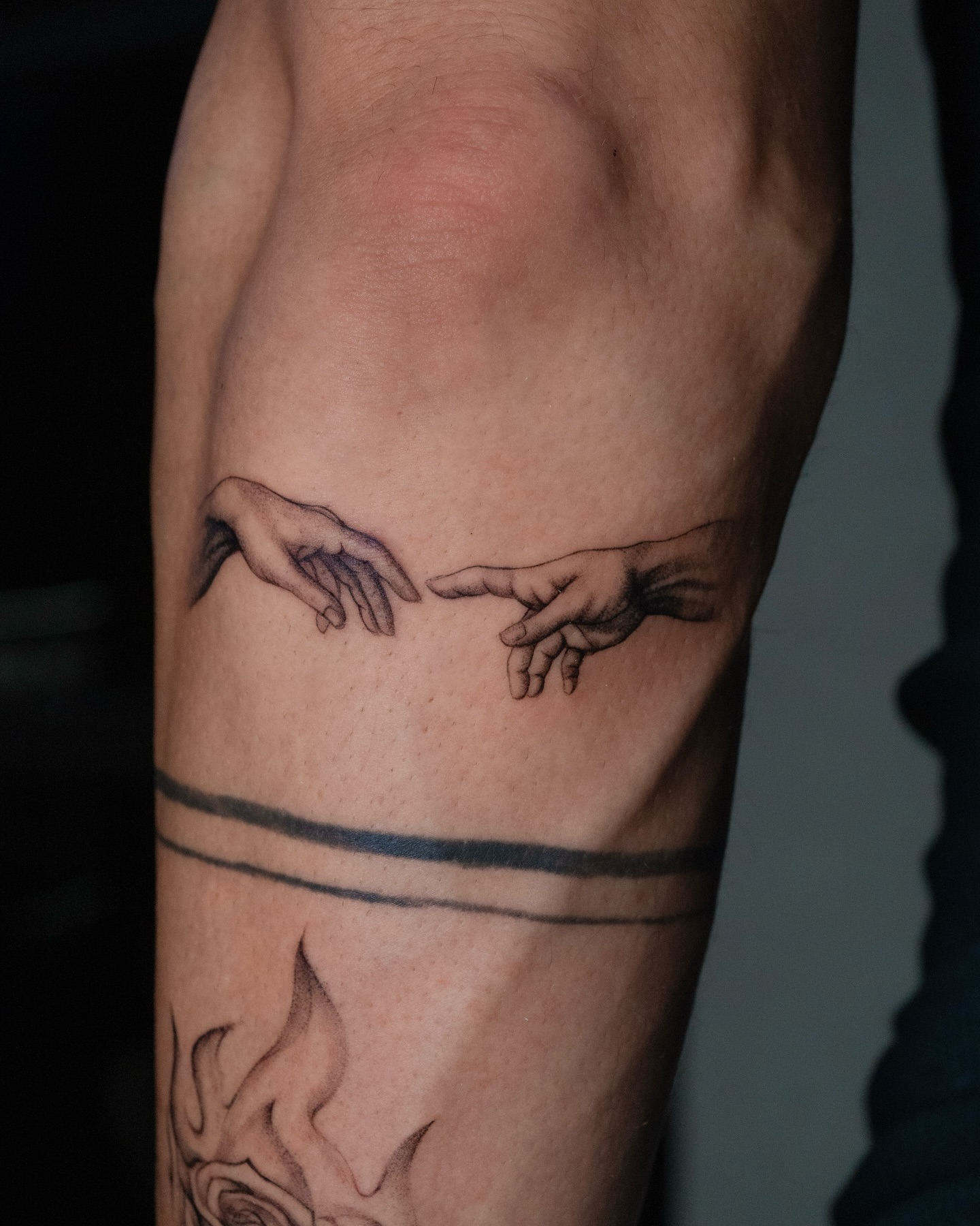 Hands reaching black and grey tattoo on the forearm by Valery Cardona