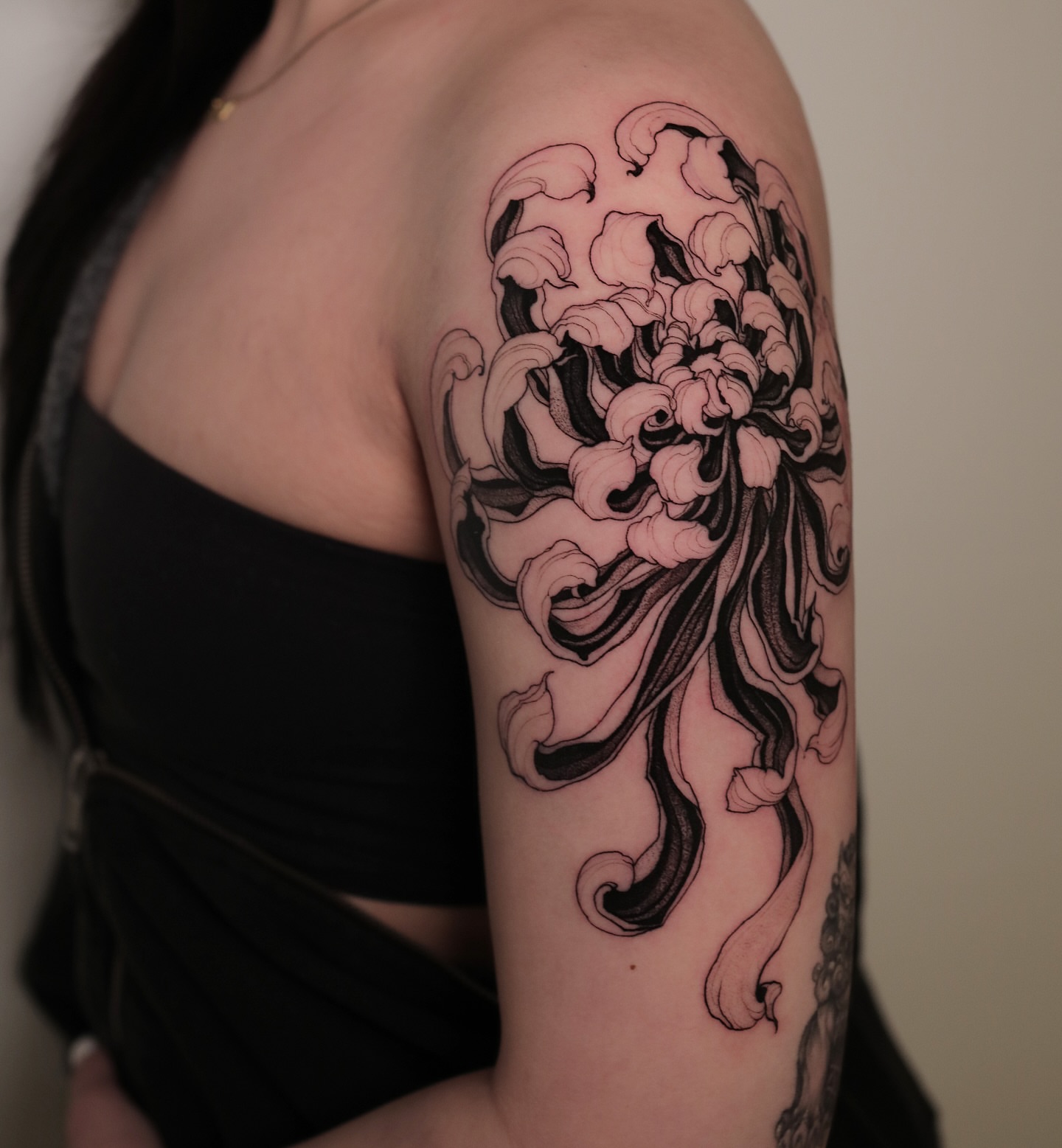 Chrysanthemum japanese irezumi tattoo on the upper arm by Strokin Konstantin
