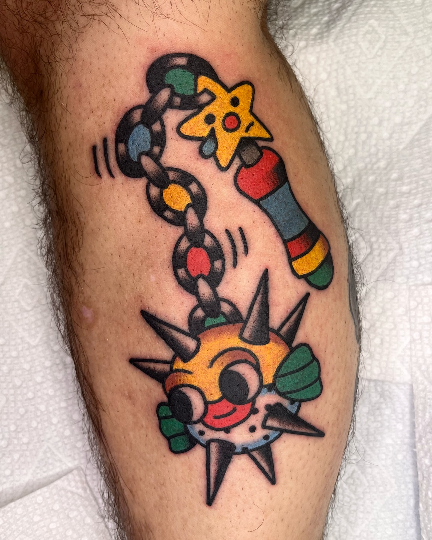 Chain and starfish American traditional tattoo on the forearm by Robyn Fricke