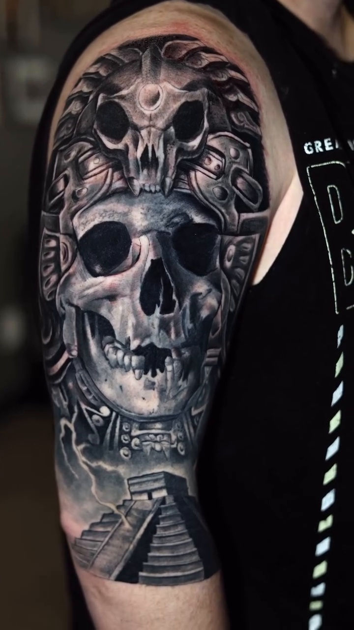 Aztec skull with headdress and pyramid dark realism tattoo by Luis Arenas