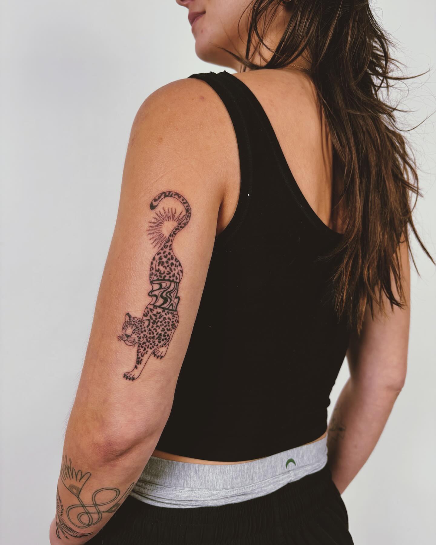 Cheetah black and grey tattoo on the upper arm by b i l l i e, Seattle, Washington