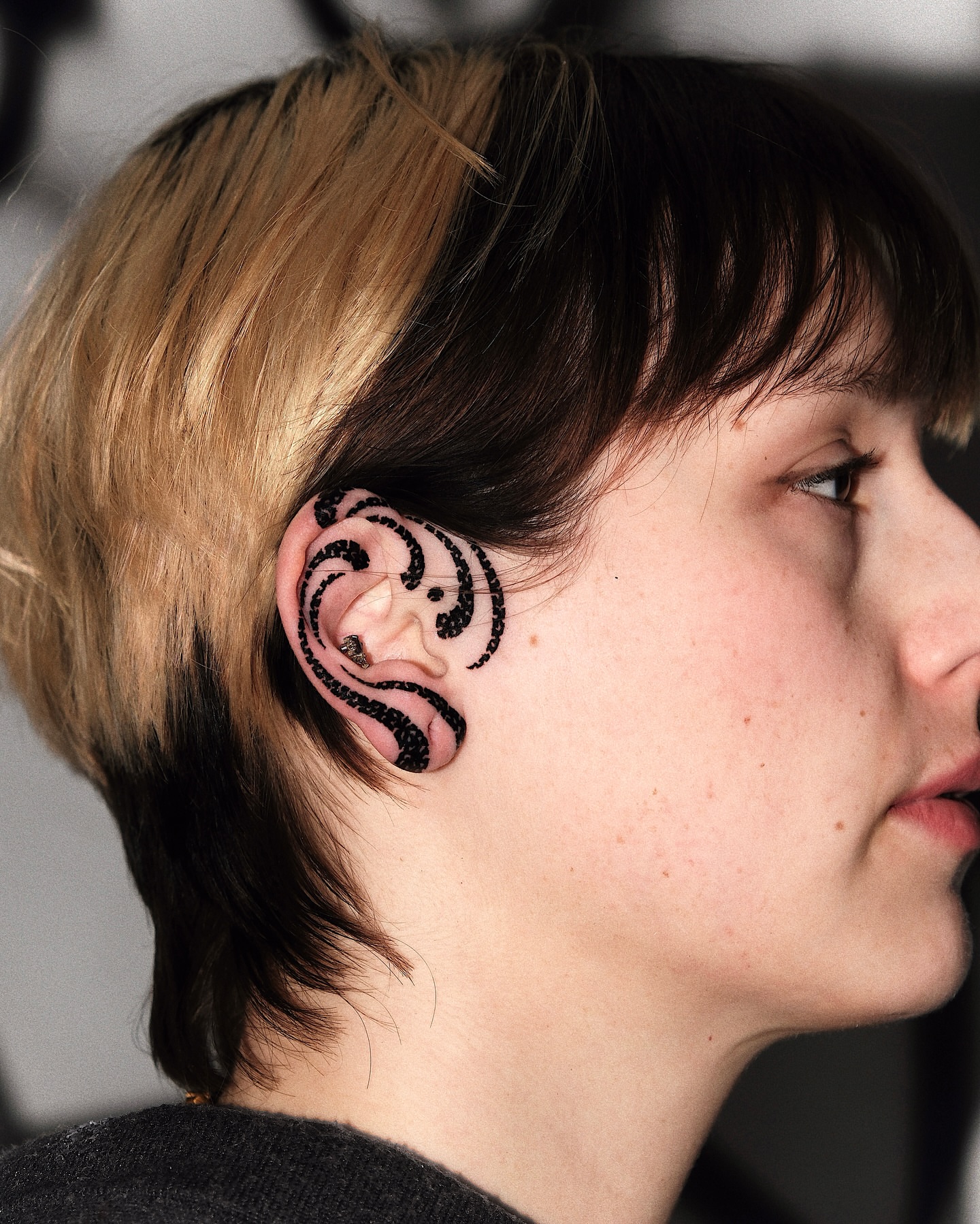 Ear tattoo blackwork tattoo on the head by Mooro