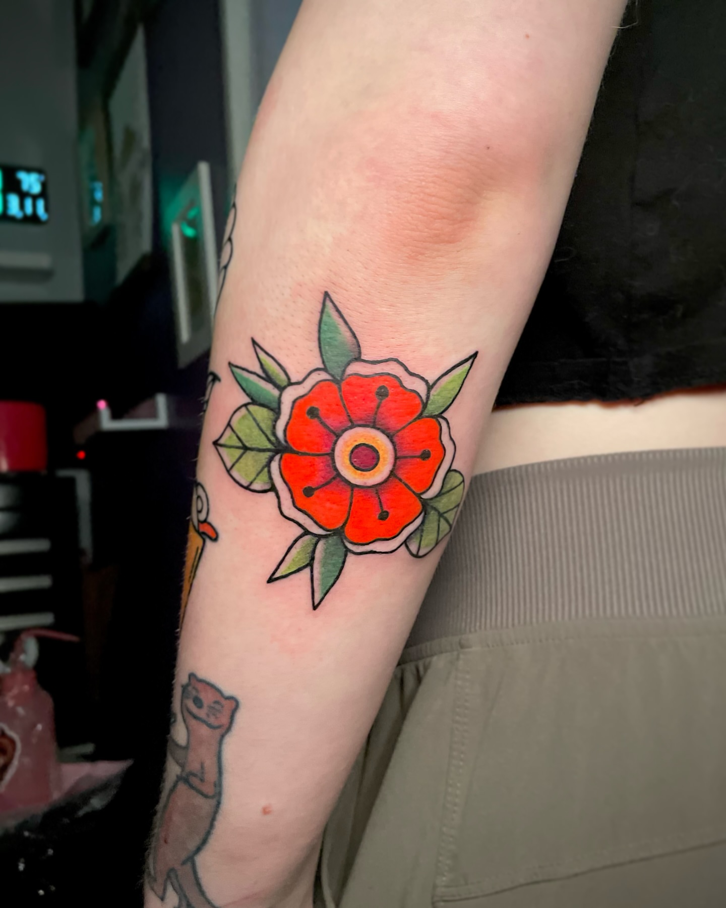 Red flower American traditional tattoo on the forearm by Liv